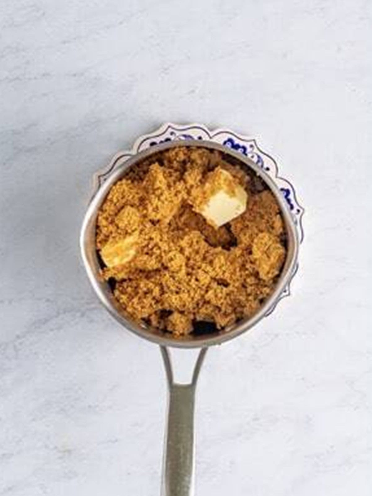 Butter and dark brown sugar melting together in a saucepan.
