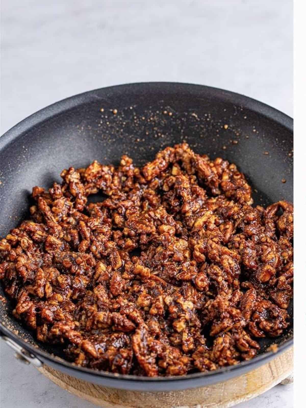 Candied cinnamon pecans coated and ready to spread out.