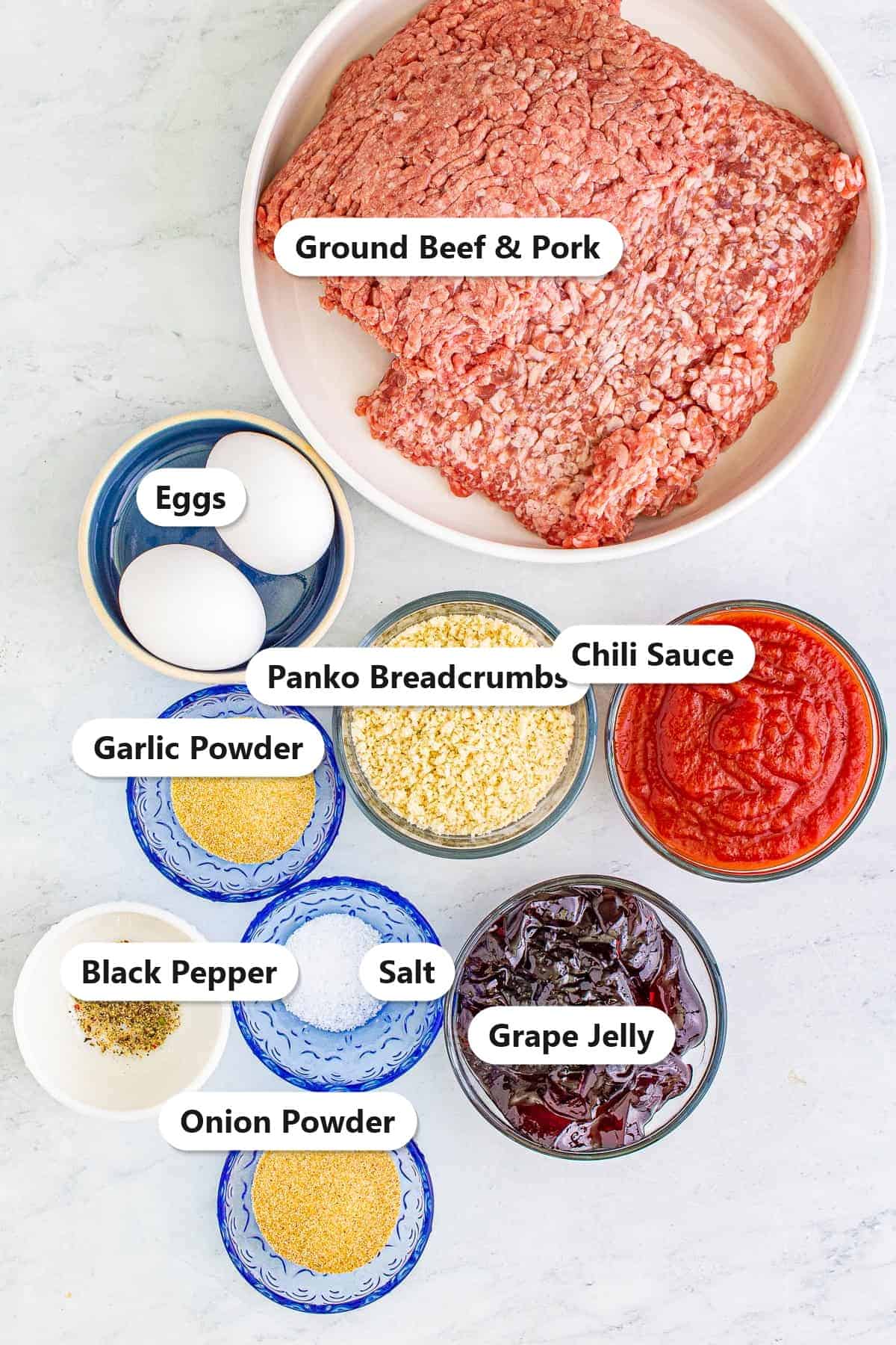 Labeled grape jelly meatballs ingredients including ground beef and pork, grape jelly, chili sauce, panko, eggs, and spices.