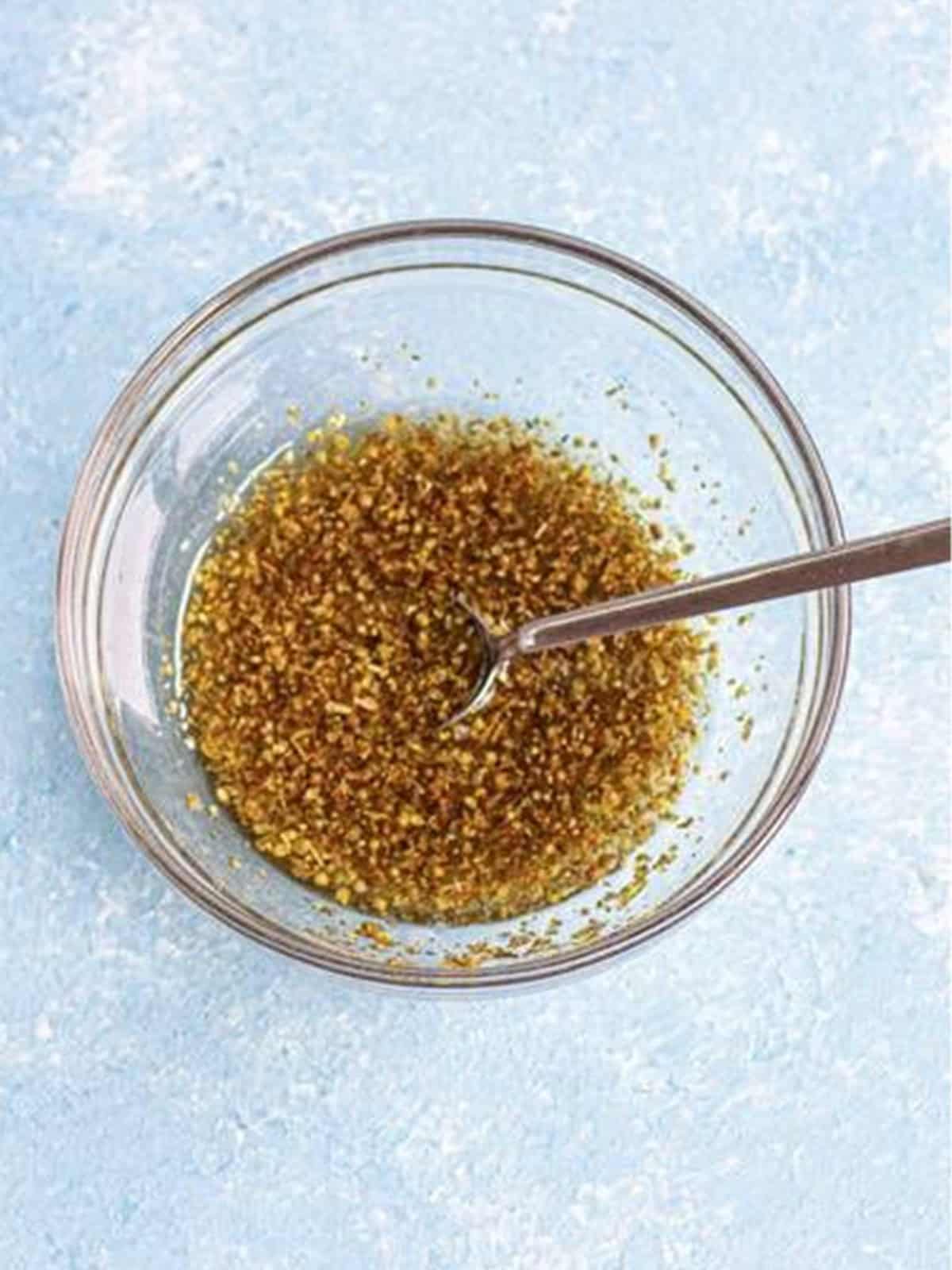 Greek lemon dressing and marinade whisked together in a bowl.