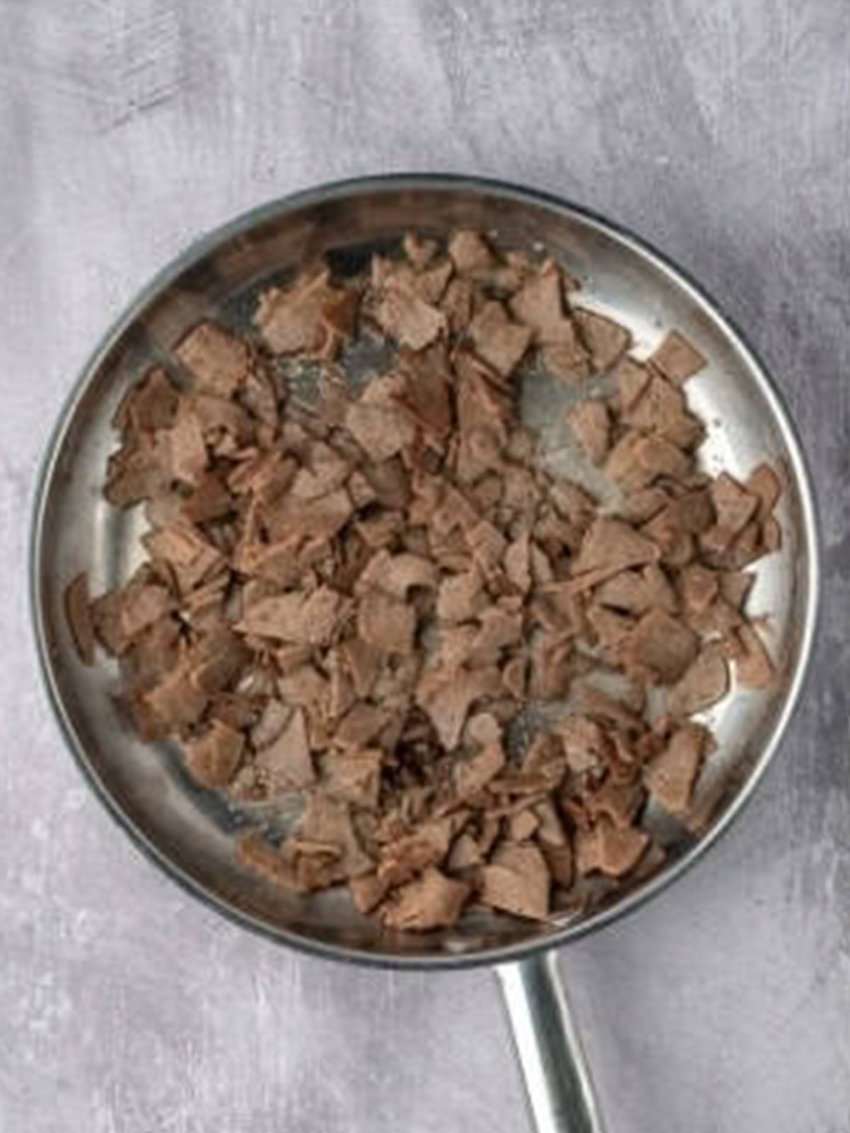 Browning chopped gyro meat in a skillet.