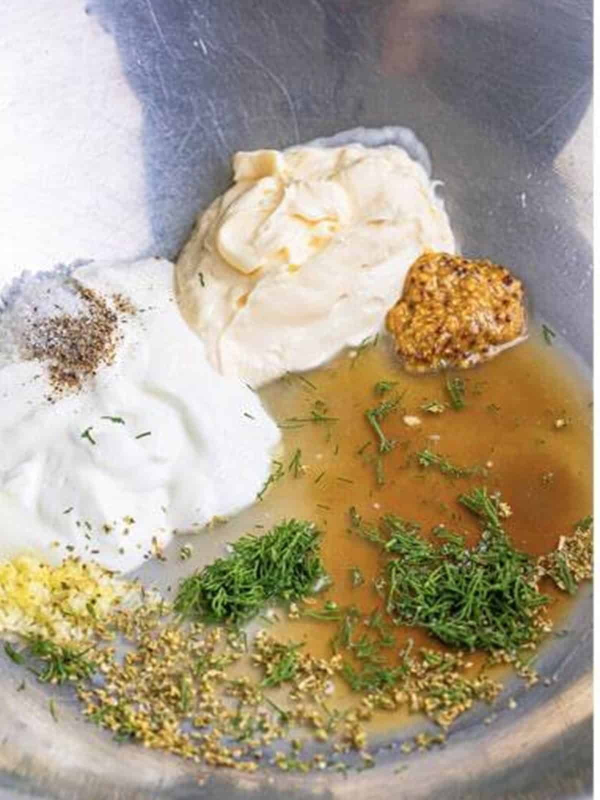 Dressing ingredients for Greek Pasta Salad added to a large metal bowl.