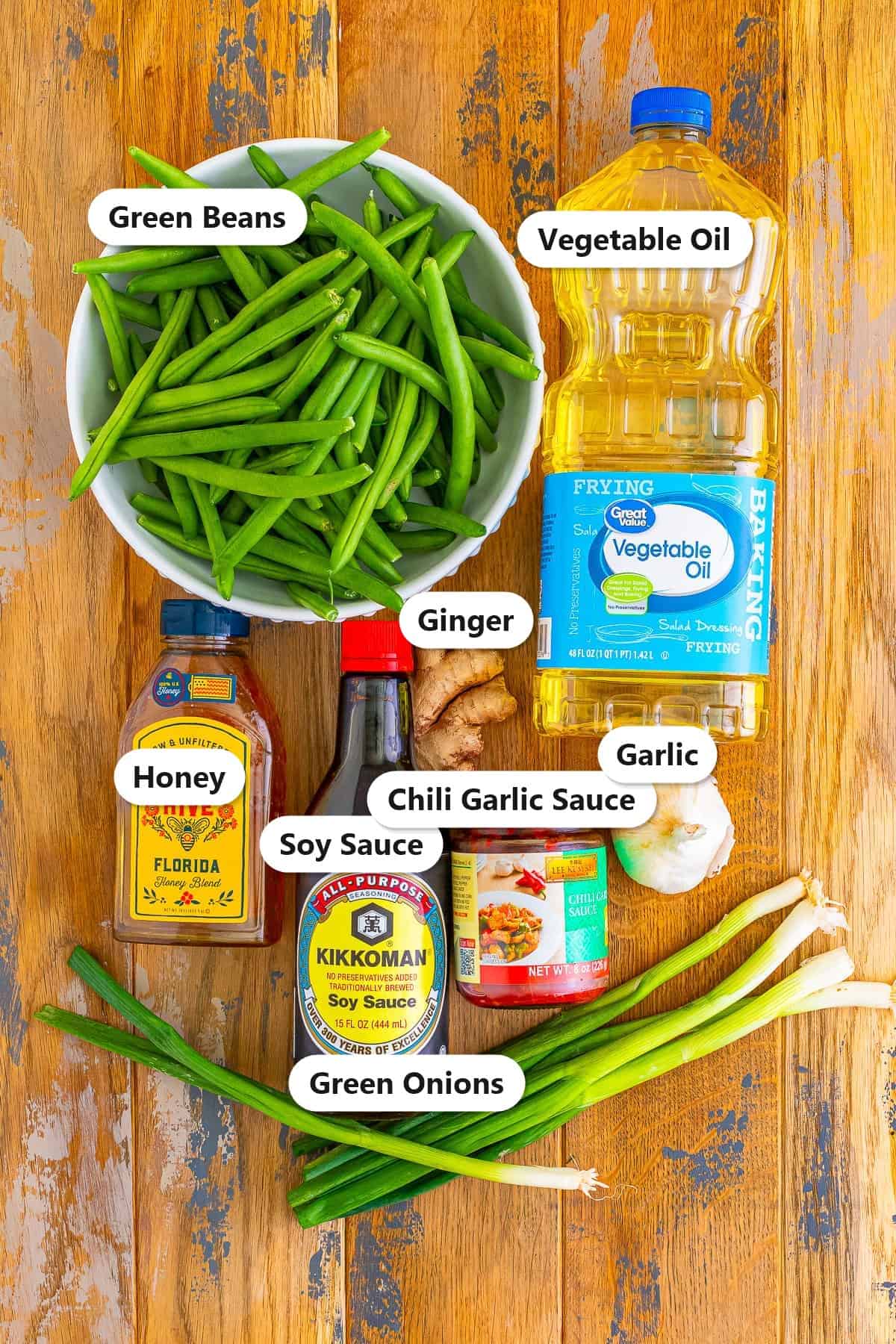 Green Bean Stir Fry ingredients including green beans, vegetable oil, ginger, honey, soy sauce, chili garlic sauce, garlic, and green onions labeled on a board.