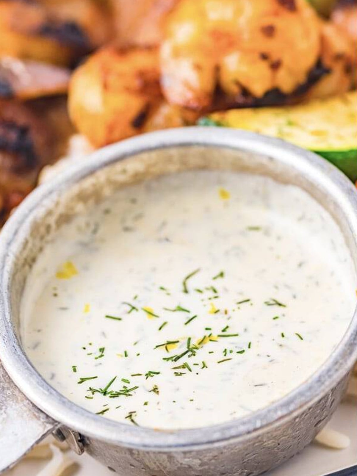 Lemon dill sauce mixed in a bowl for grilled shrimp skewers.