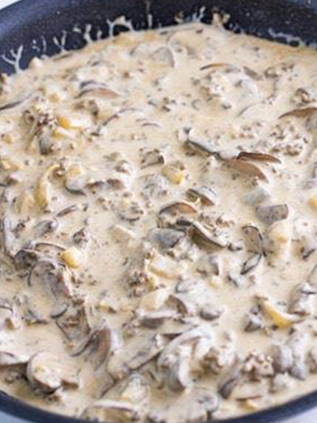 Finished creamy ground beef stroganoff in a skillet.