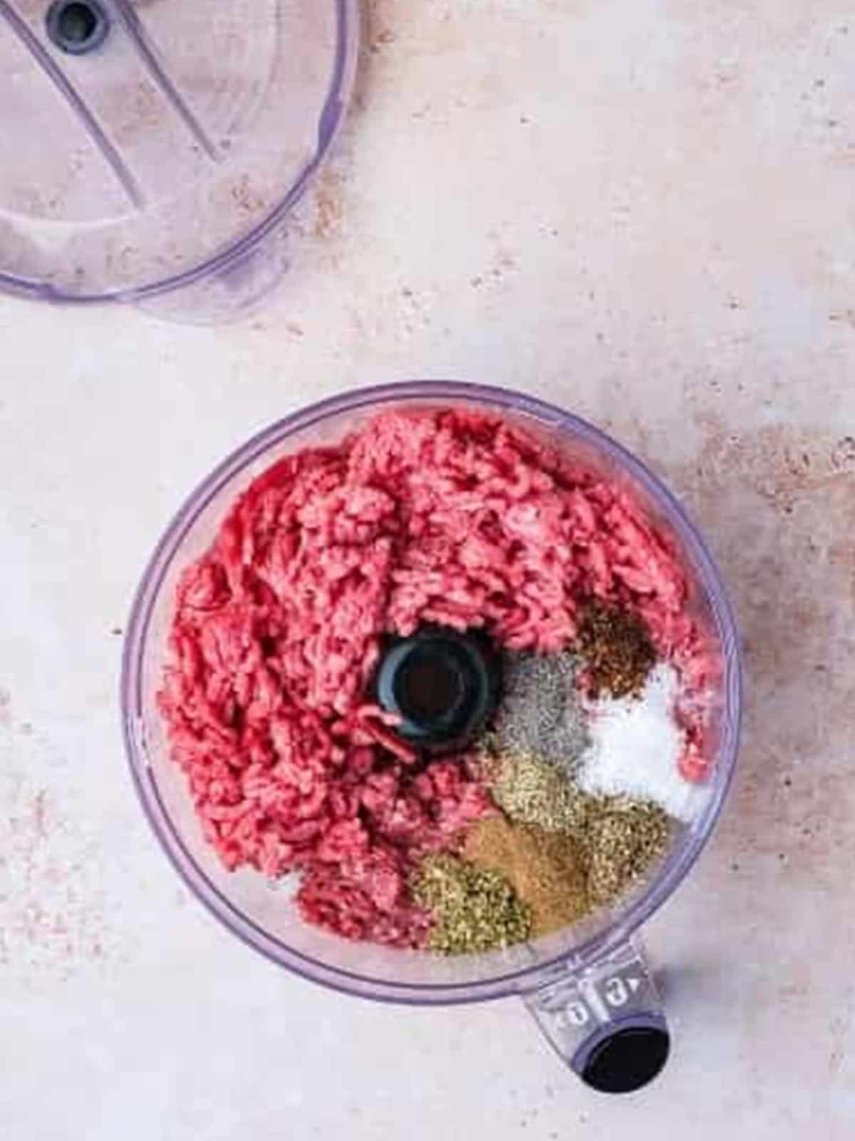 Ground lamb and beef with Greek seasonings in a food processor for gyro meat