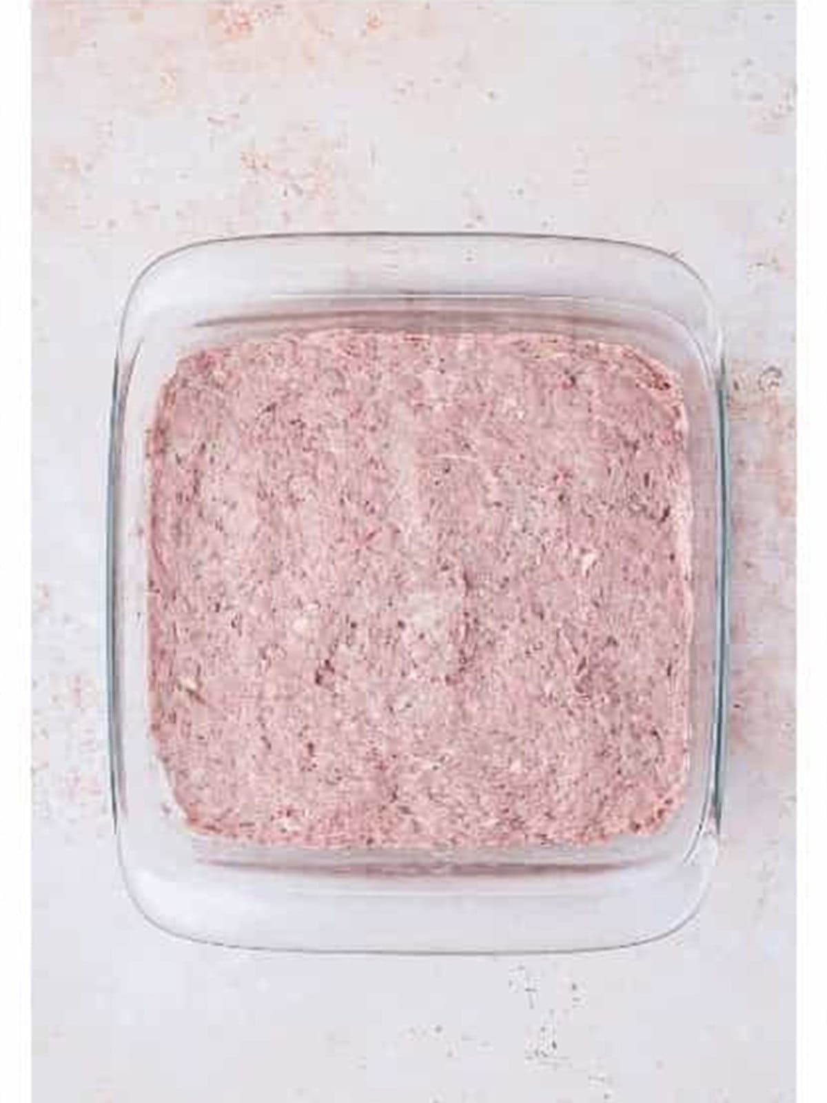 Gyro meat mixture packed firmly into a baking dish