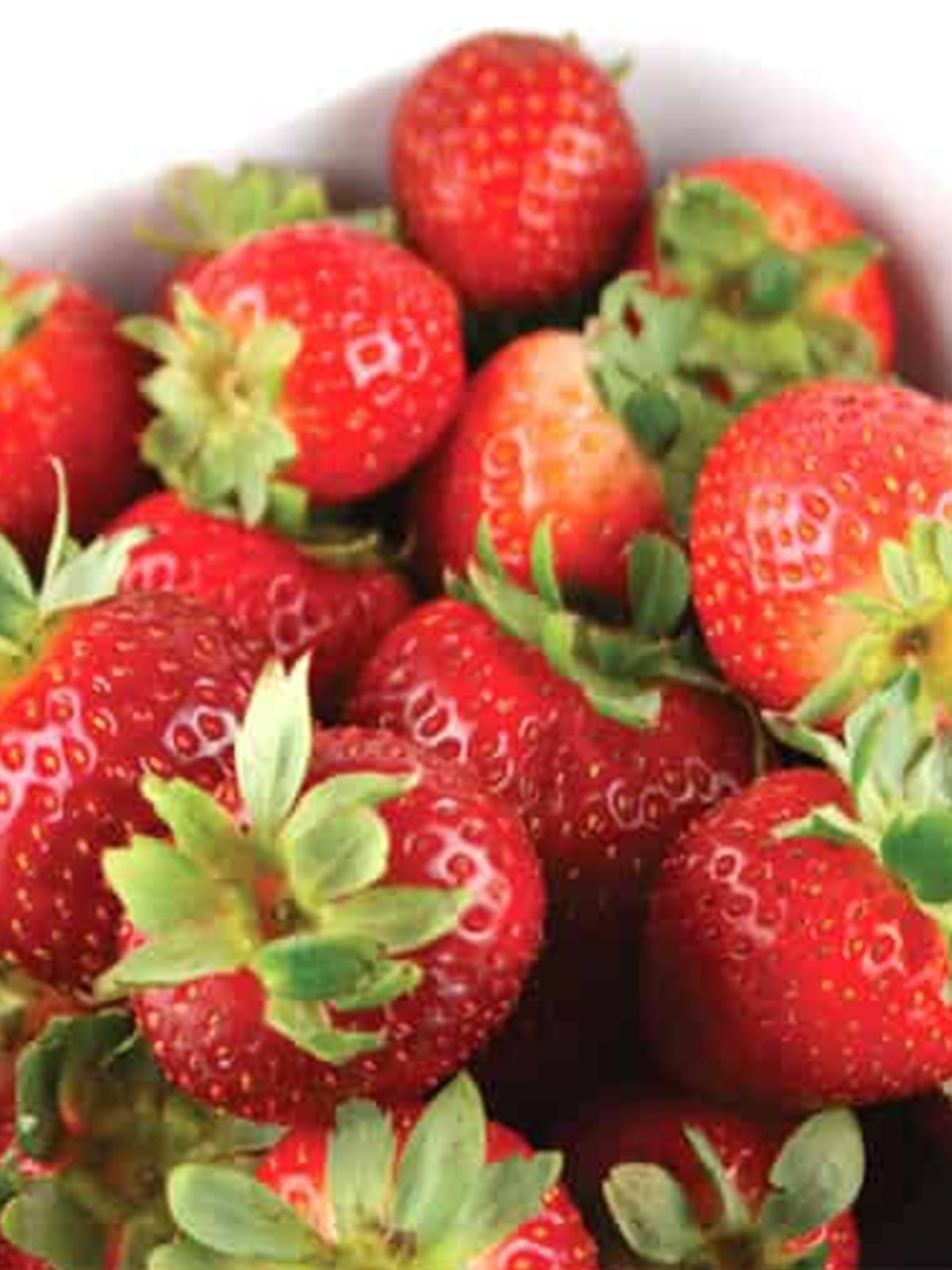 Fresh strawberries in a bowl ready to be dipped for halloween chocolate covered strawberries.