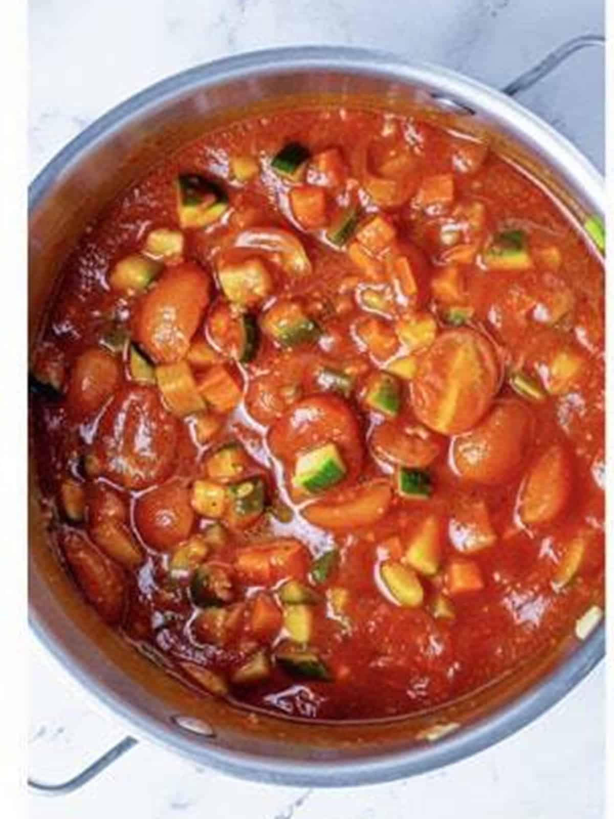 Tomato sauce stirred into the sauteed vegetables and simmering on the stove.
