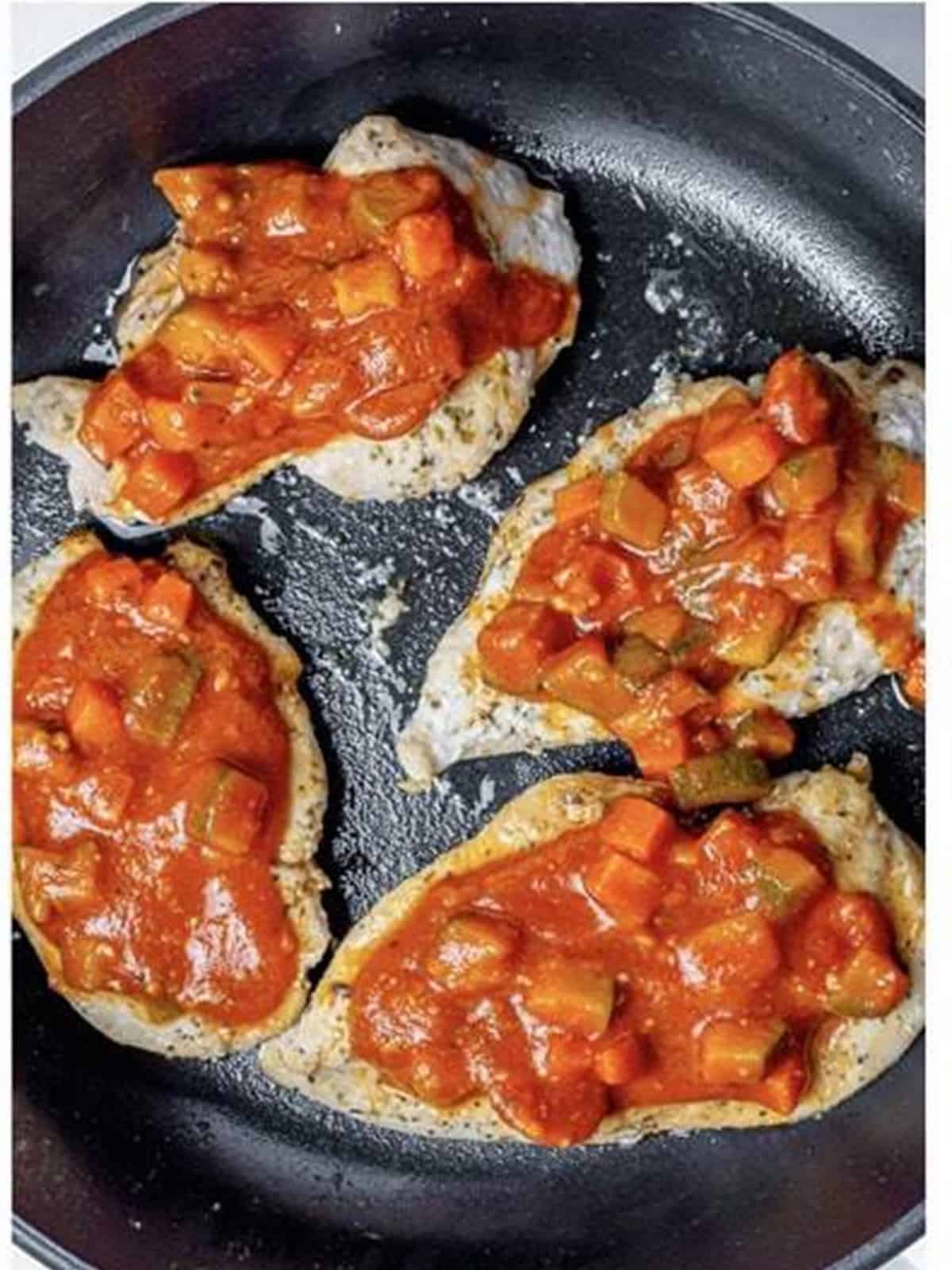 Seared chicken breasts topped with chunky veggie marinara sauce.