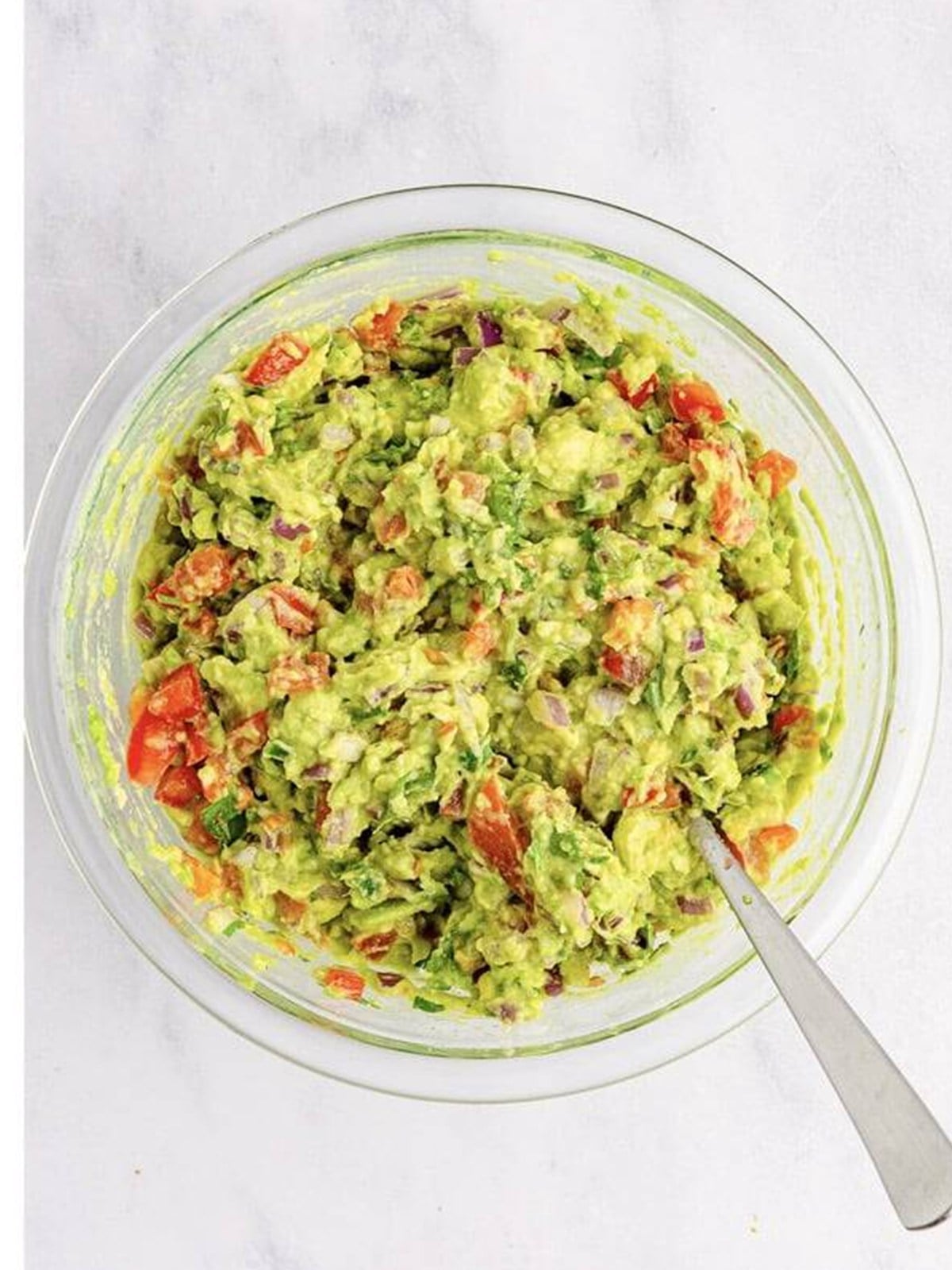 Finished homemade guacamole mixed in a bowl ready to serve.
