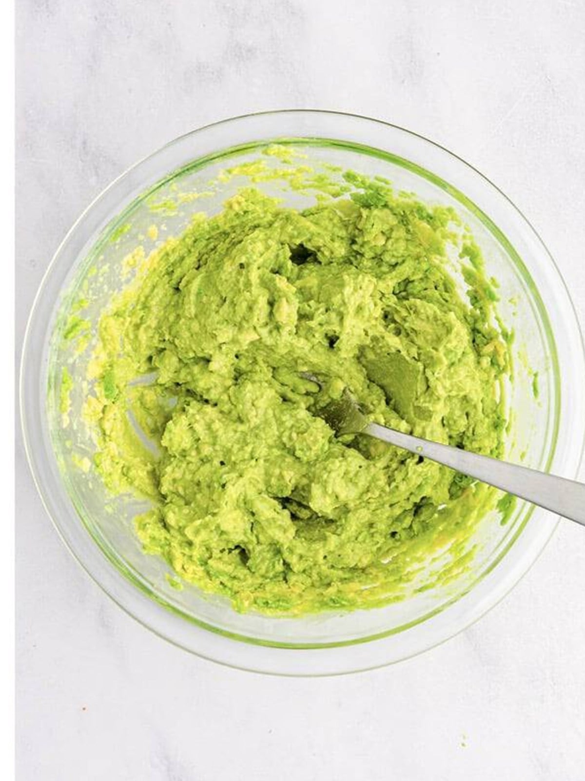 Mashed avocado seasoned with lime juice, garlic, and salt for guacamole.