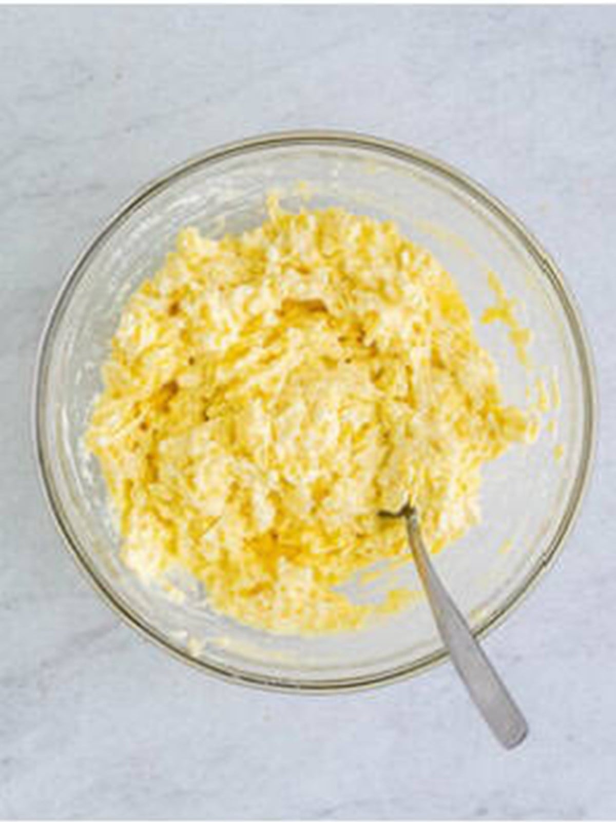 Ricotta cheese filling mixed in a glass bowl for homemade lasagna.