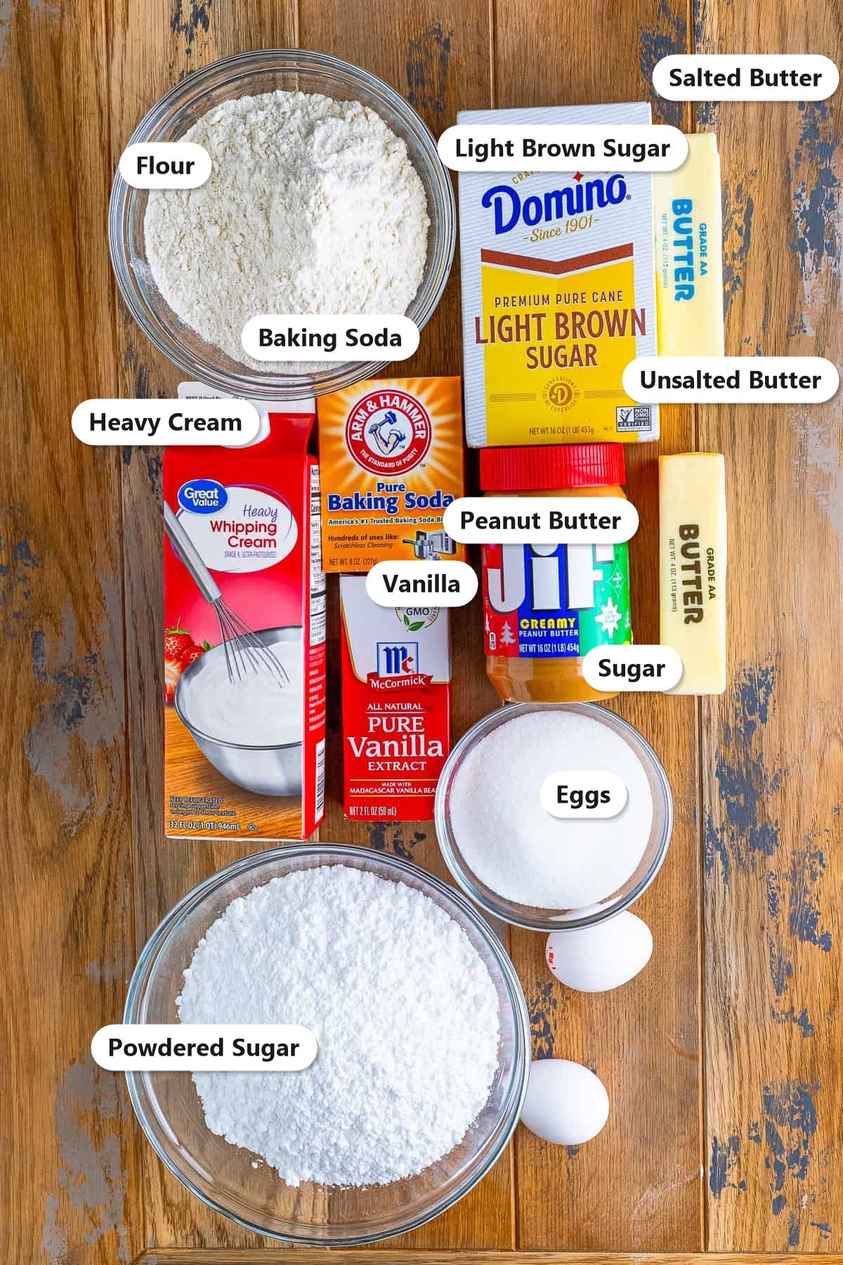 Labeled ingredients for homemade nutter butter cookies including peanut butter, flour, sugars, butter, eggs, and heavy cream.