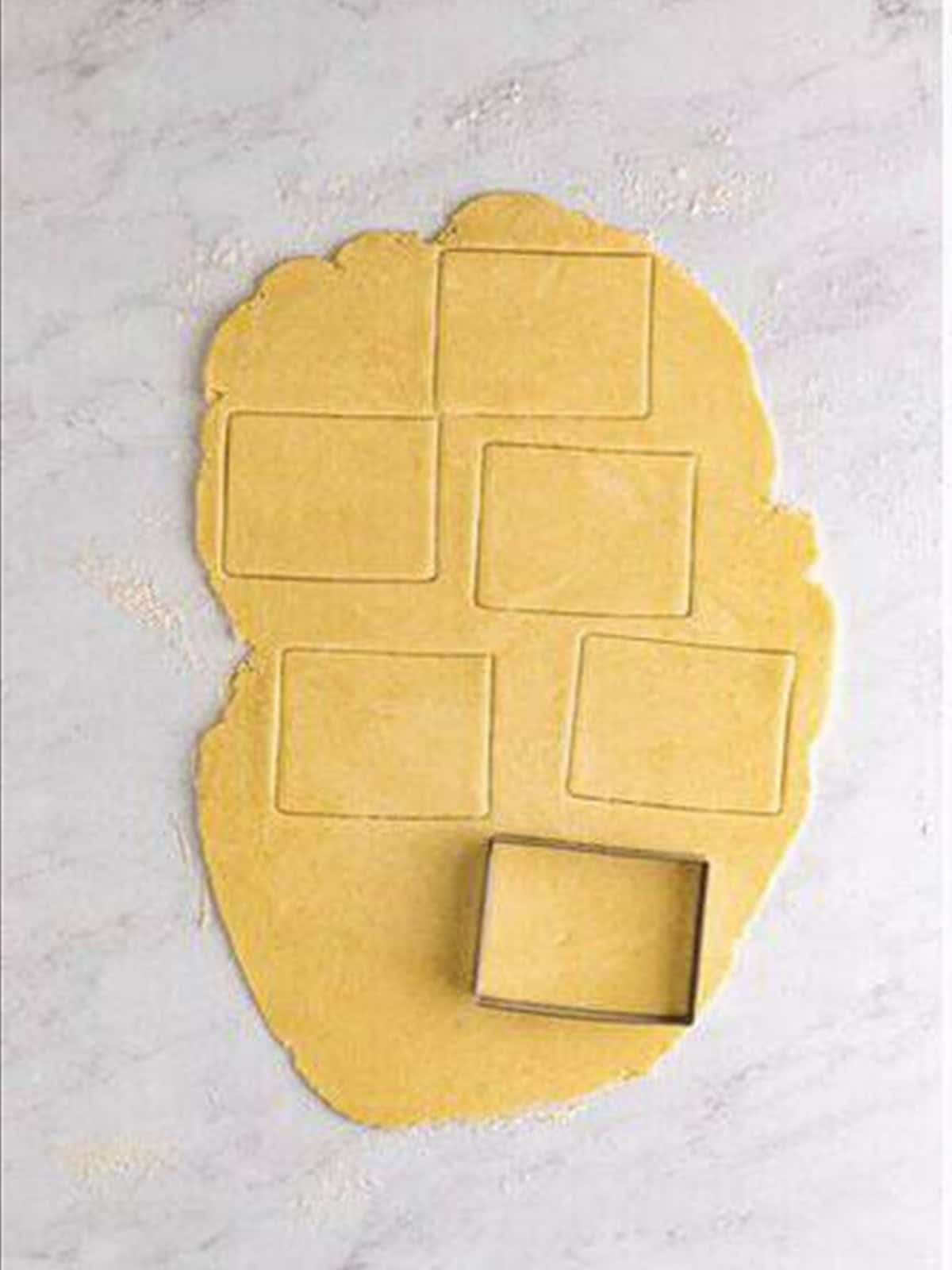 Rolling and cutting the dough into rectangles for homemade pop tarts.