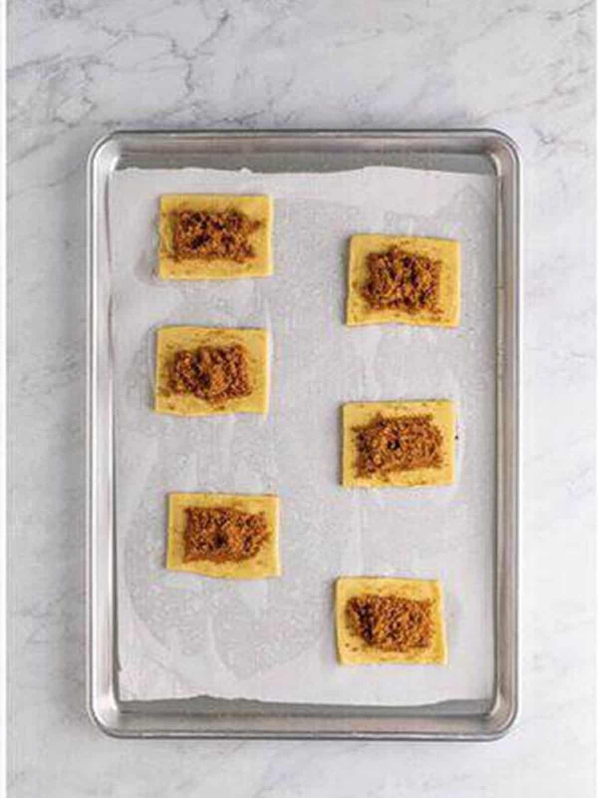 Adding filling to the dough rectangles for homemade pop tarts.