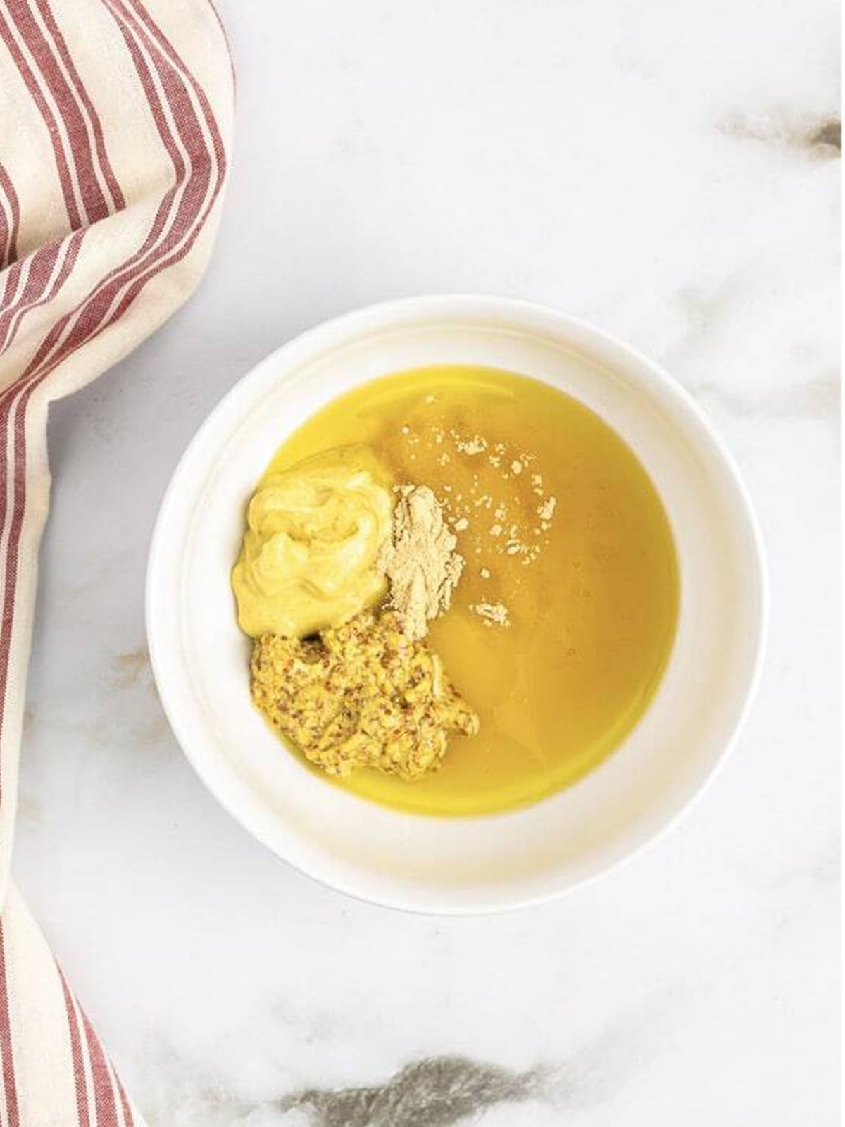 Honey mustard dressing ingredients in a bowl before whisking.