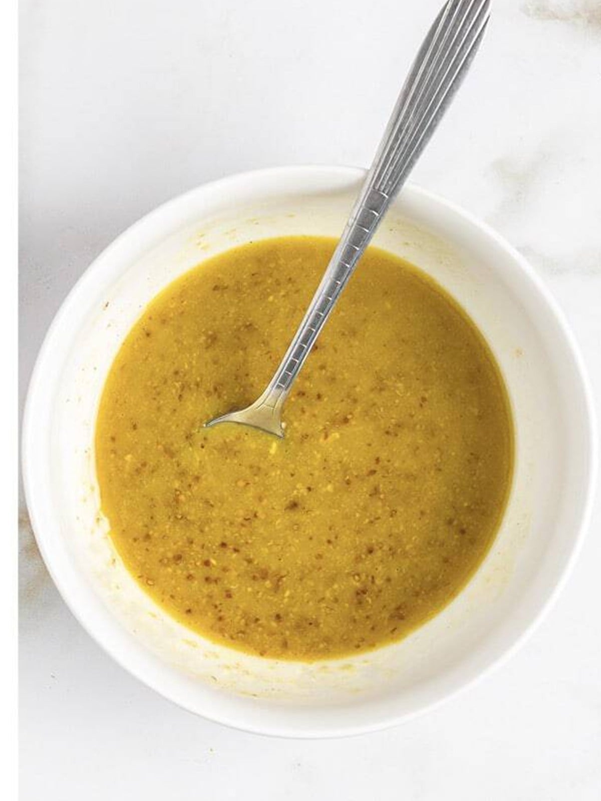 Whisked honey mustard dressing in a bowl.