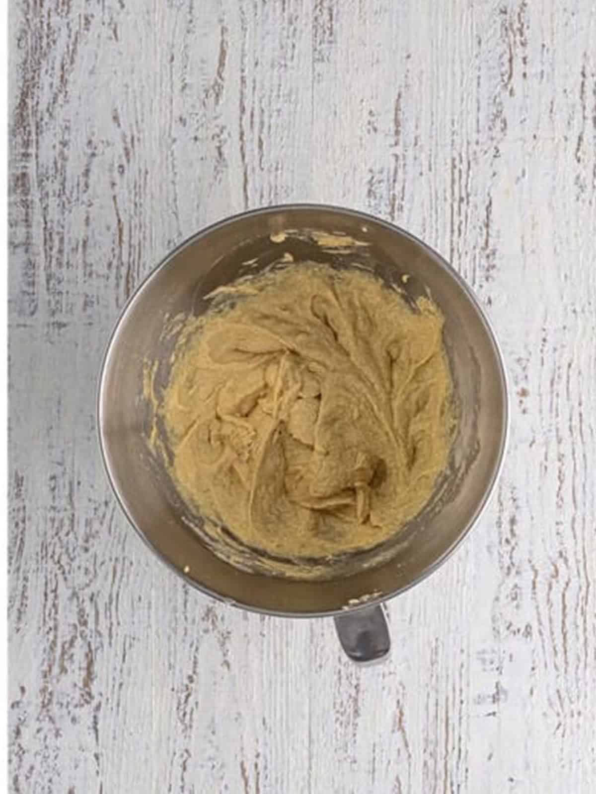 Chocolate hot cocoa cookie dough mixed in a stand mixer bowl.