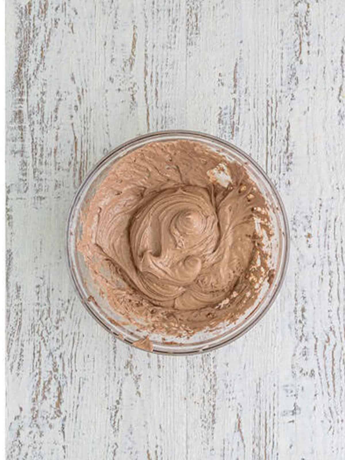 Smooth marshmallow hot cocoa frosting mixed in a bowl for the cookies.