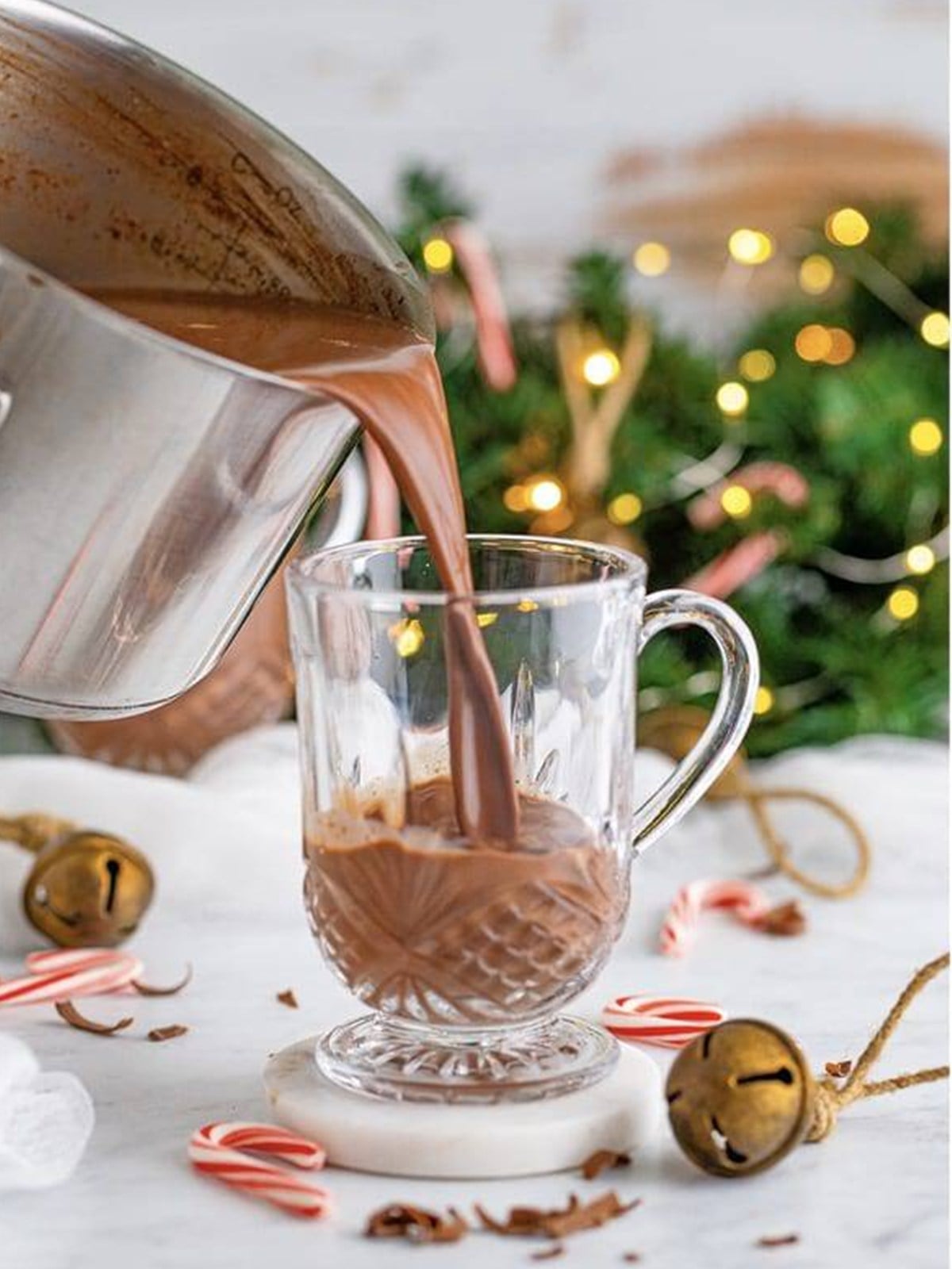 Rich homemade hot chocolate poured into a clear glass mug.