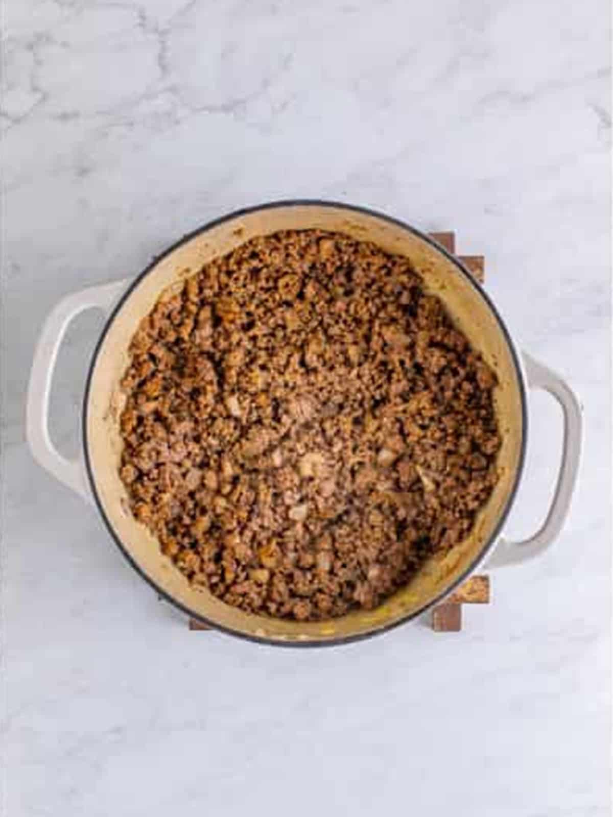 Spiced ground beef stirred until the seasonings are fragrant.