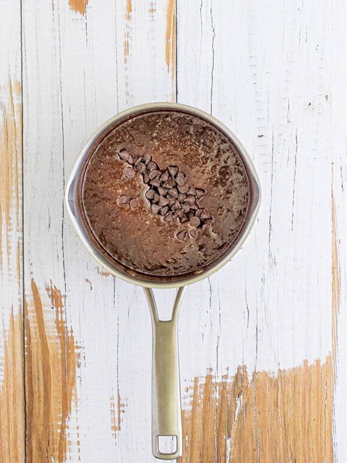 Smooth melted chocolate hot fudge sauce in a saucepan.
