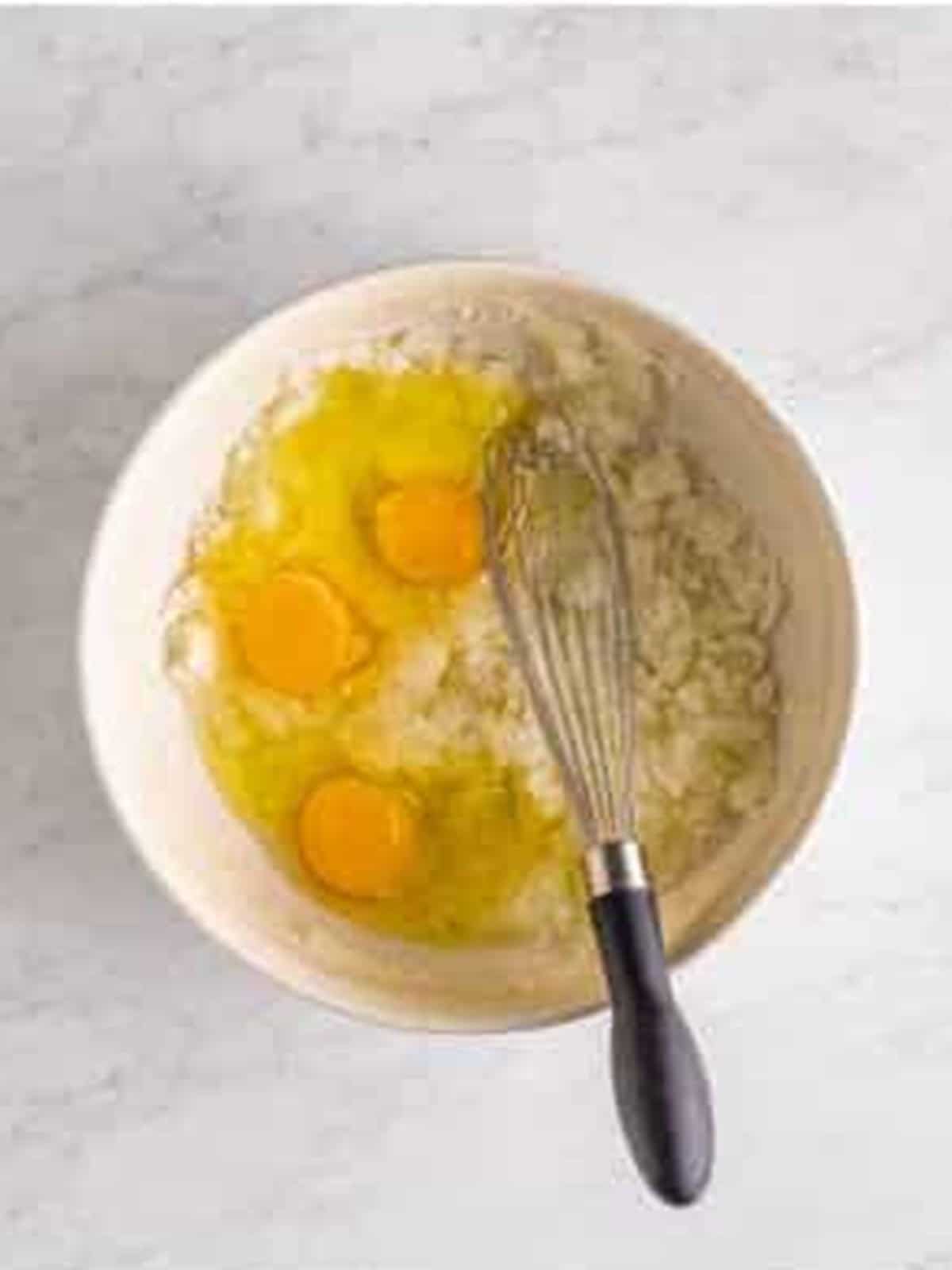 Whisking eggs into the sugar and oil mixture for Hummingbird Cake.