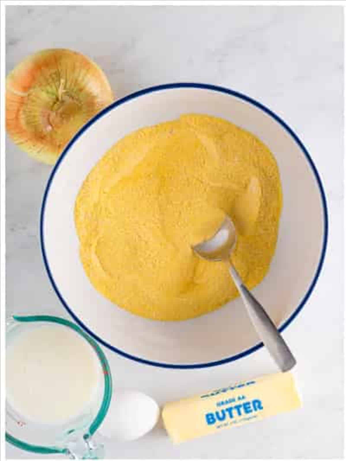 Cornmeal and dry ingredients in a bowl for hush puppy recipe.