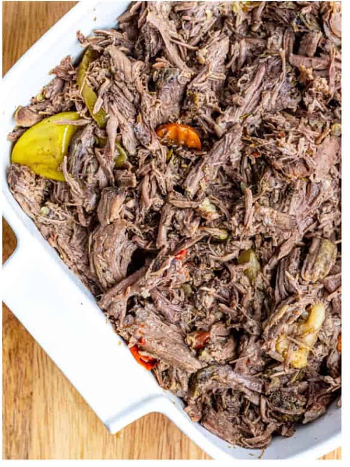 Tender slow cooker Italian beef shredded with two forks.