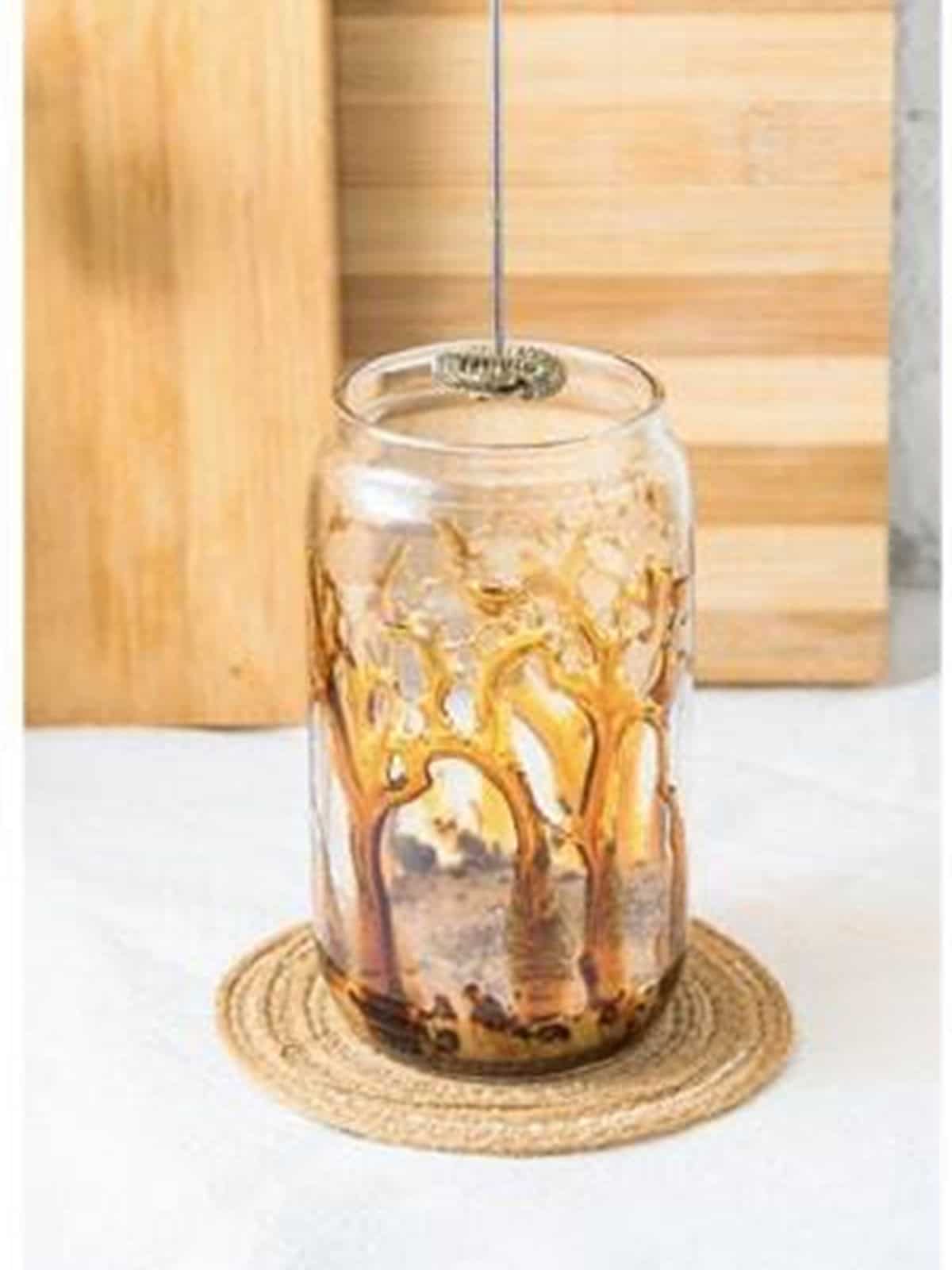 Frothing the coffee mixture for an iced caramel latte.