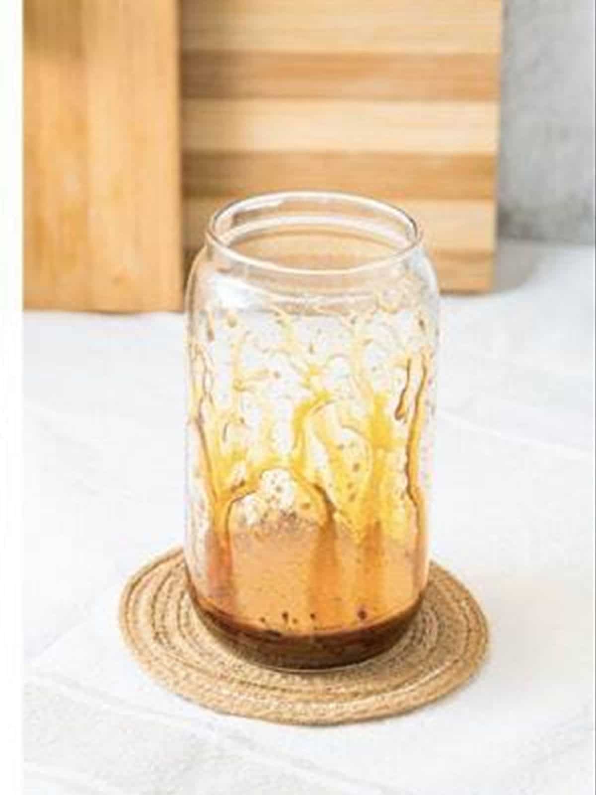 Drizzling caramel inside the glass for an iced caramel latte.