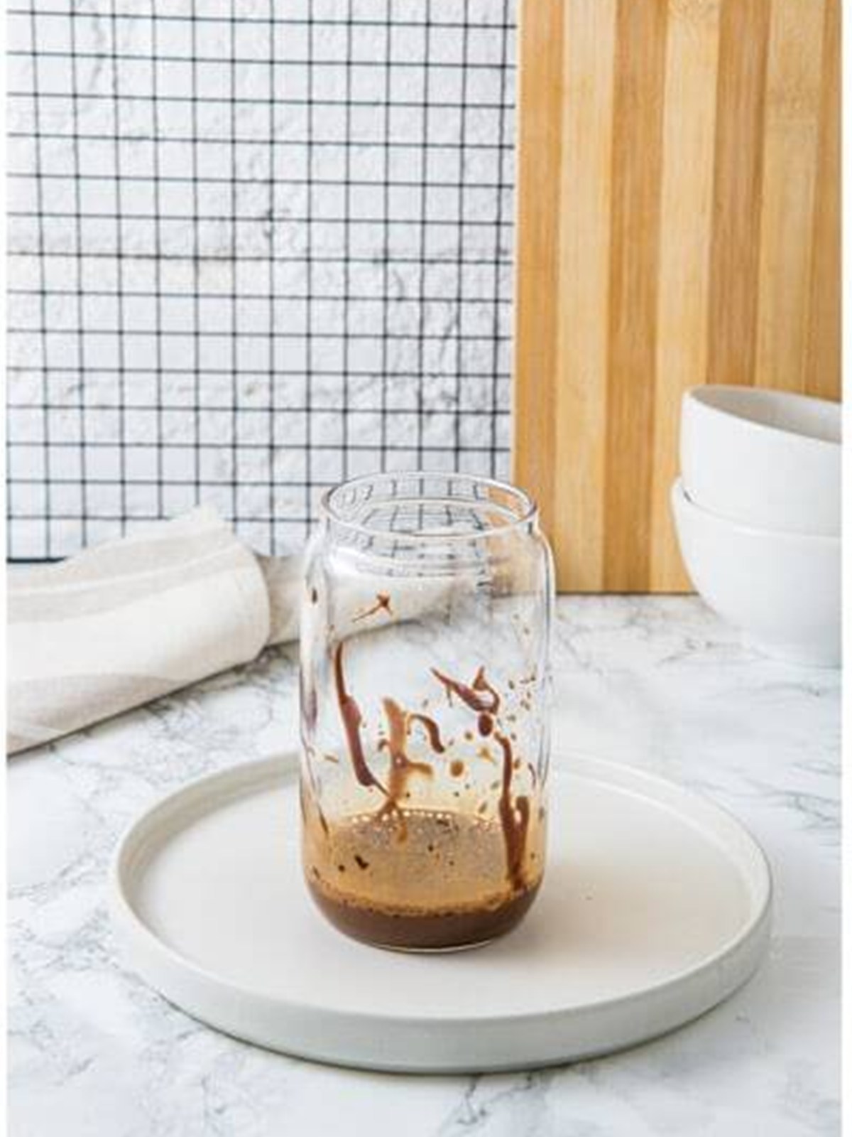 Adding a splash of milk to the coffee mixture for an Iced Mocha.