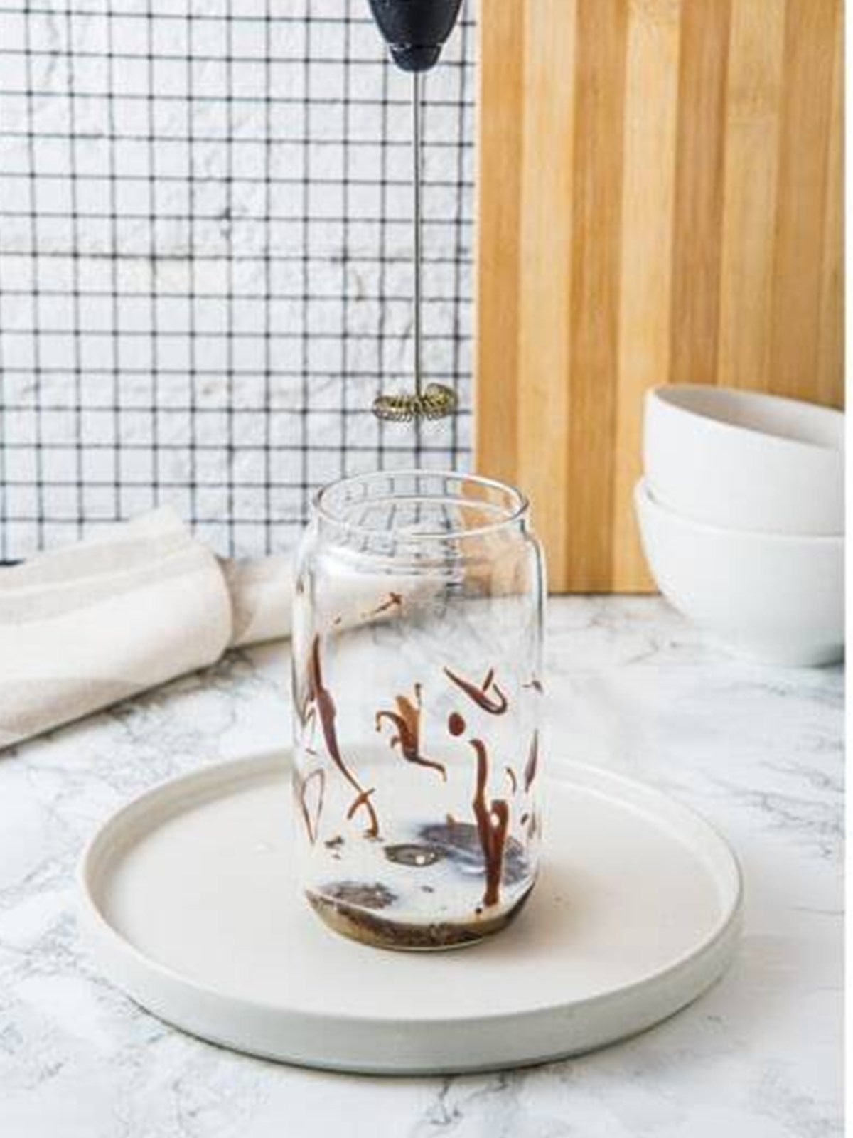 Instant coffee, brown sugar, and chocolate syrup in a tall glass to make an Iced Mocha.