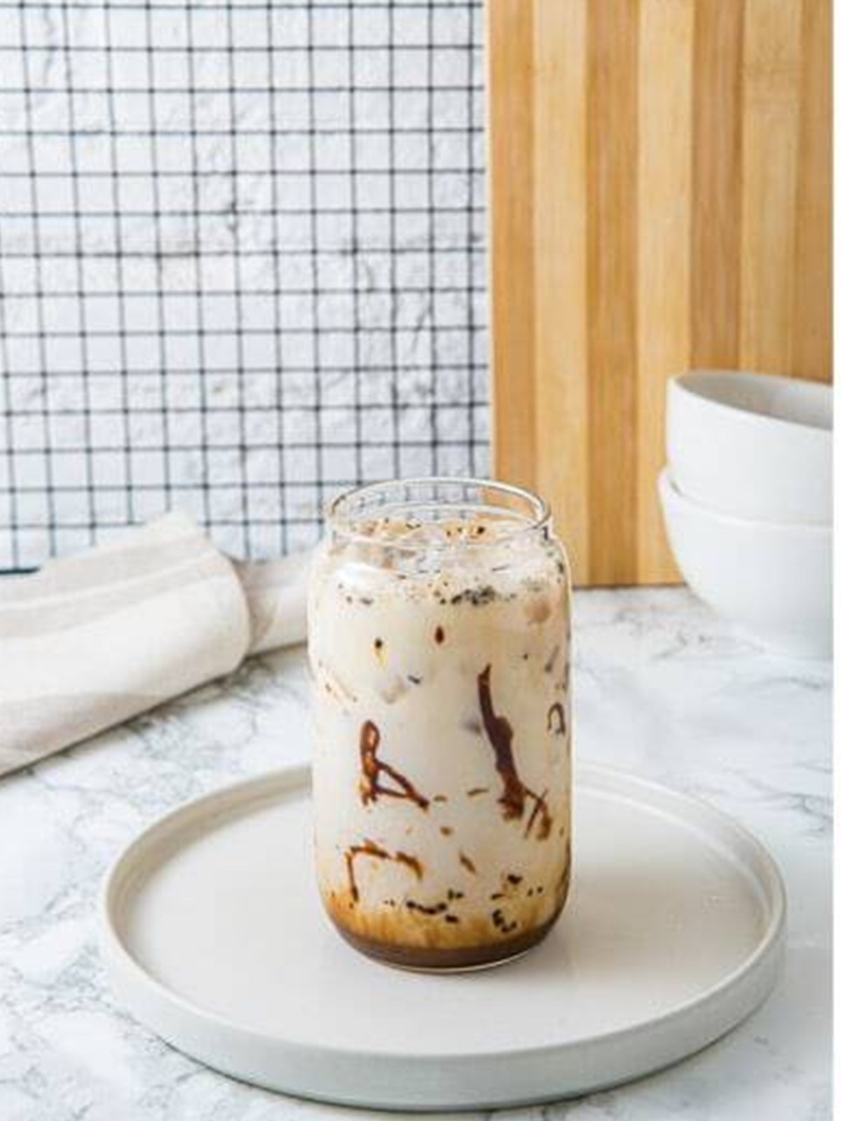 Filling the glass with ice and milk for an Iced Mocha.