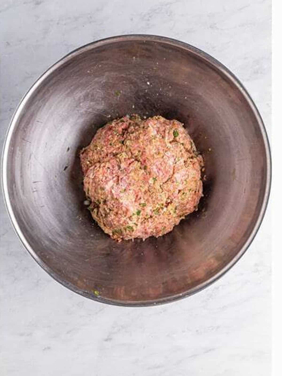 Italian meatball mixture mixed together in a bowl.
