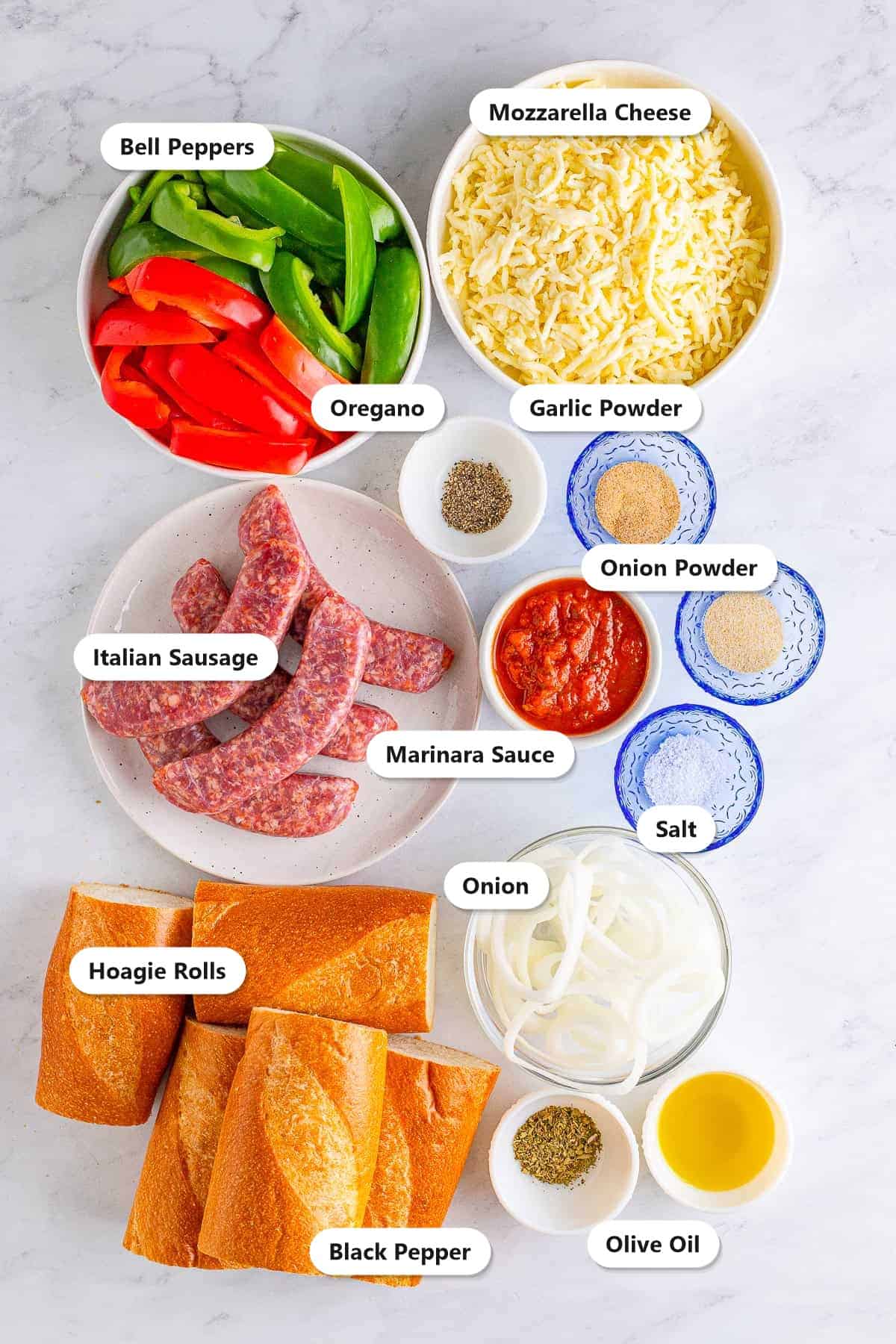 Labeled ingredients for Italian sausage sandwiches including bell peppers, onion, Italian sausage, marinara, mozzarella, hoagie rolls, and seasonings.