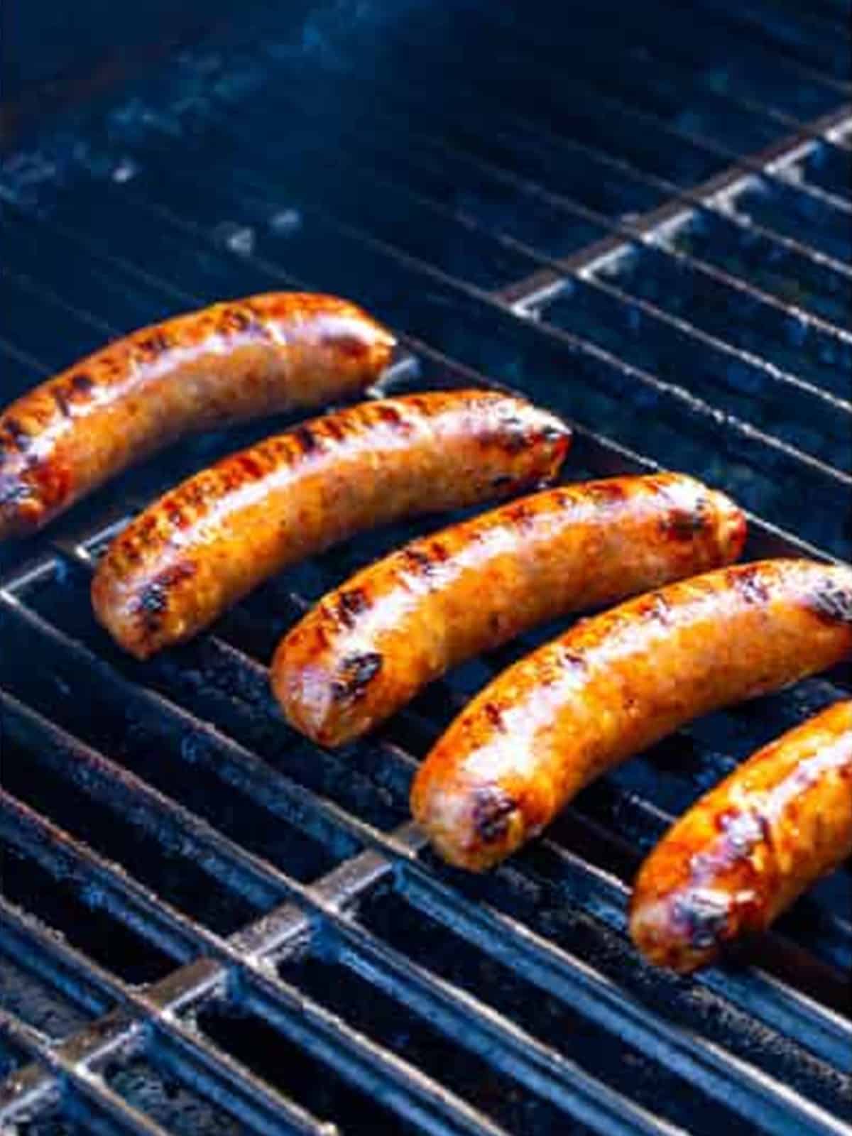 Italian sausages grilling over medium heat for Italian sausage sandwiches.