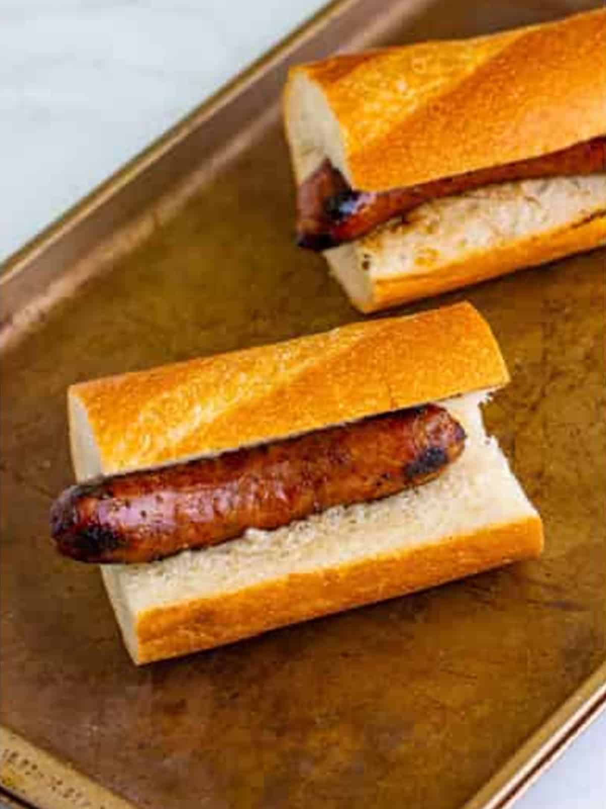 Grilled Italian sausage placed inside a hoagie roll for Italian sausage sandwiches.
