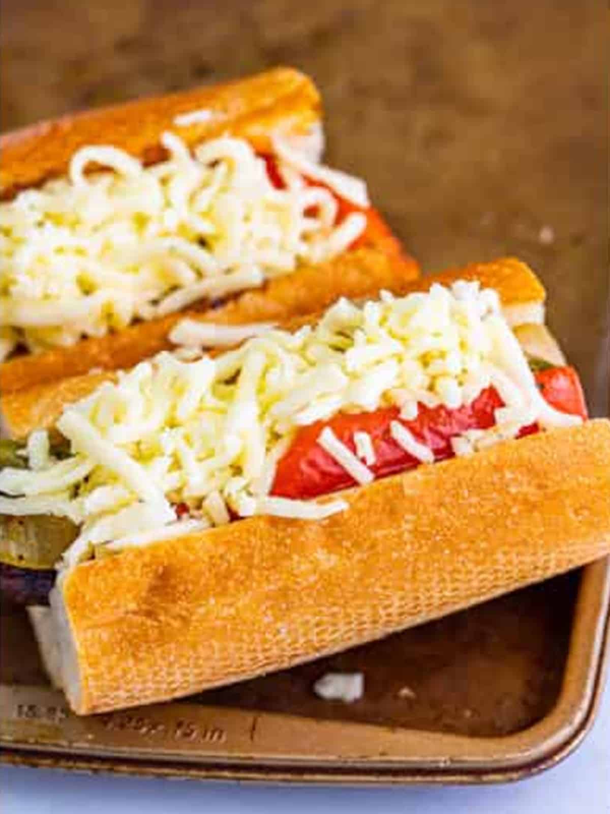 Shredded mozzarella cheese added over the Italian sausage sandwiches before baking.