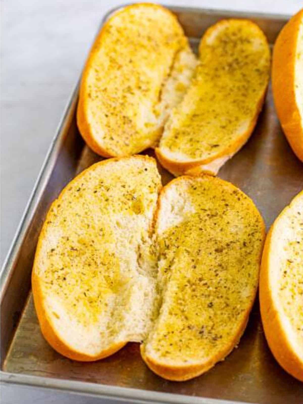 Hoagie rolls spread with garlic parmesan butter and toasted until golden.
