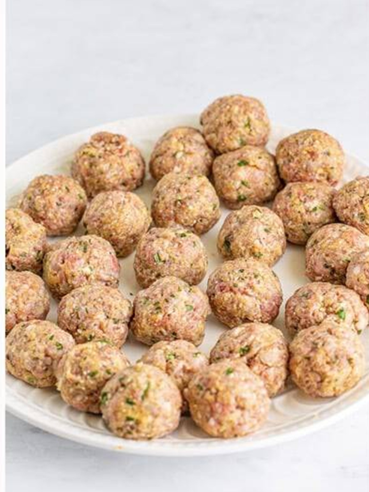 Rolling the mixture into mini meatballs for Italian Wedding Soup.