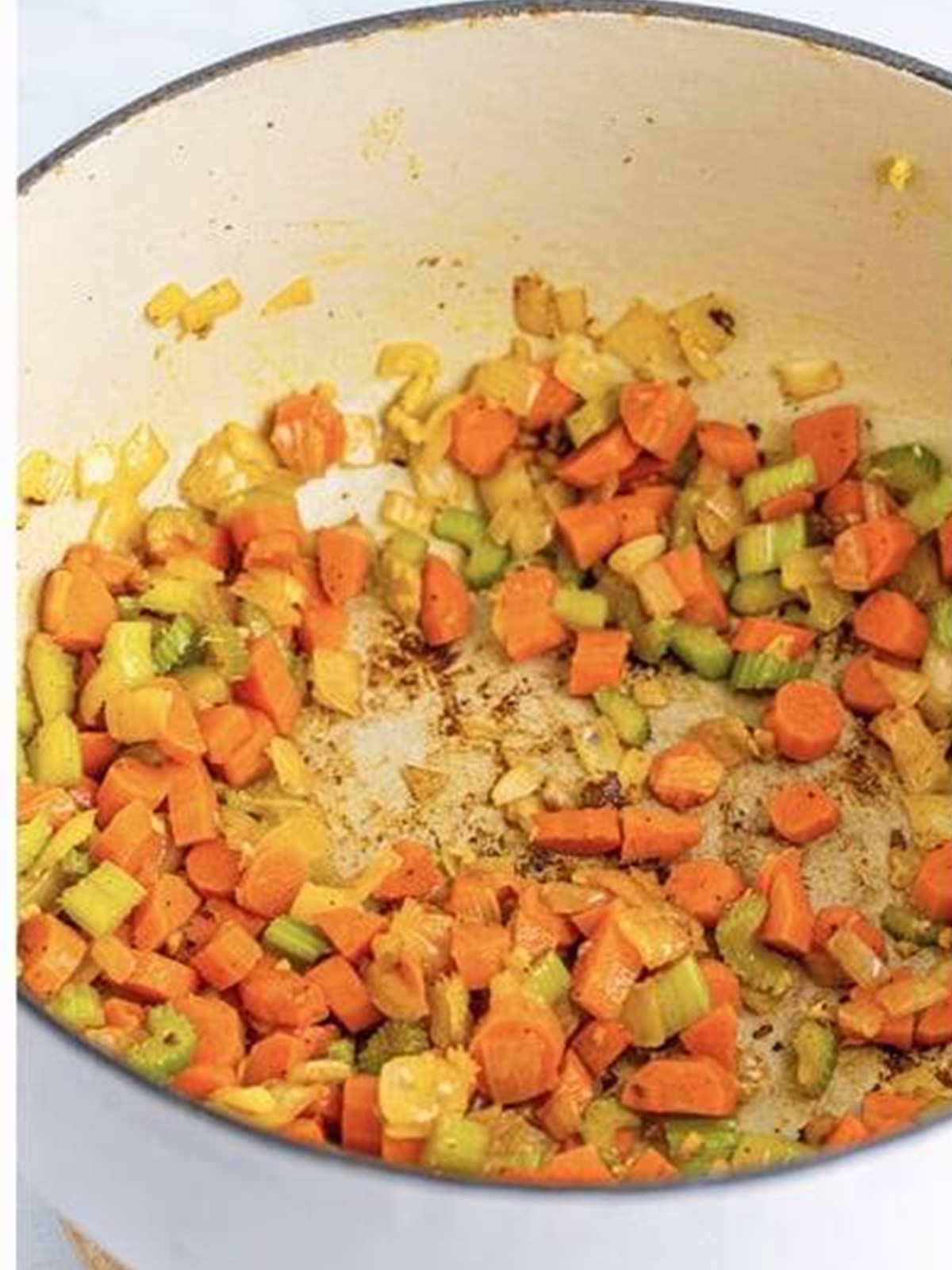 Sauteing diced carrots, celery, and onion in a Dutch oven for Italian Wedding Soup.