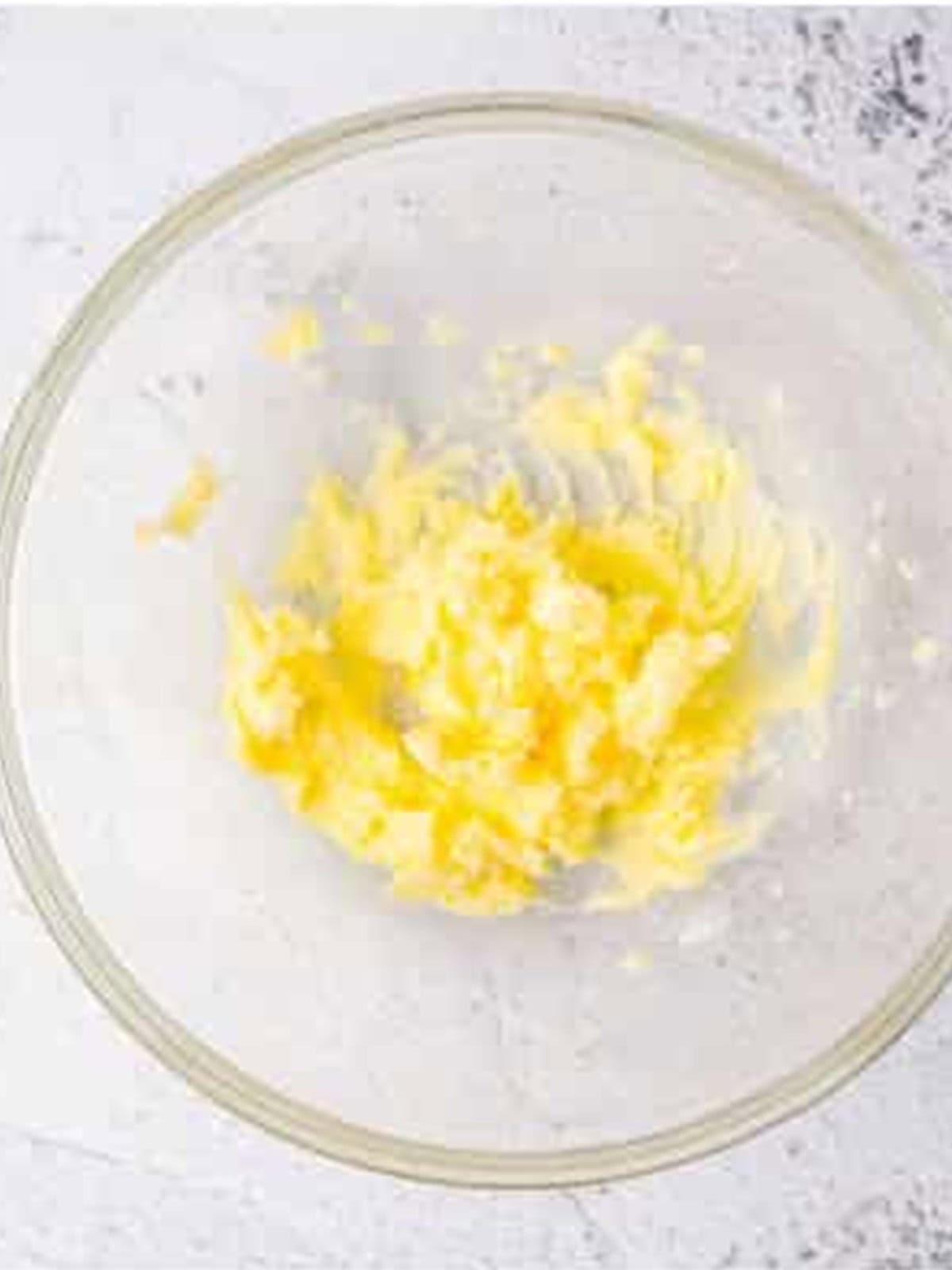 Butter and sugar beaten together in a bowl for jalapeno cornbread.