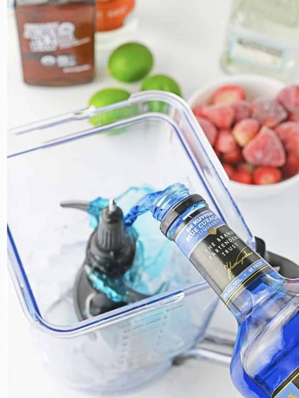 Blue curacao margarita layer being blended for a red white and blue cocktail.