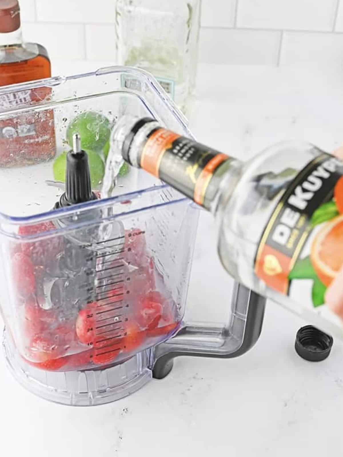 Frozen strawberry red margarita layer being blended.