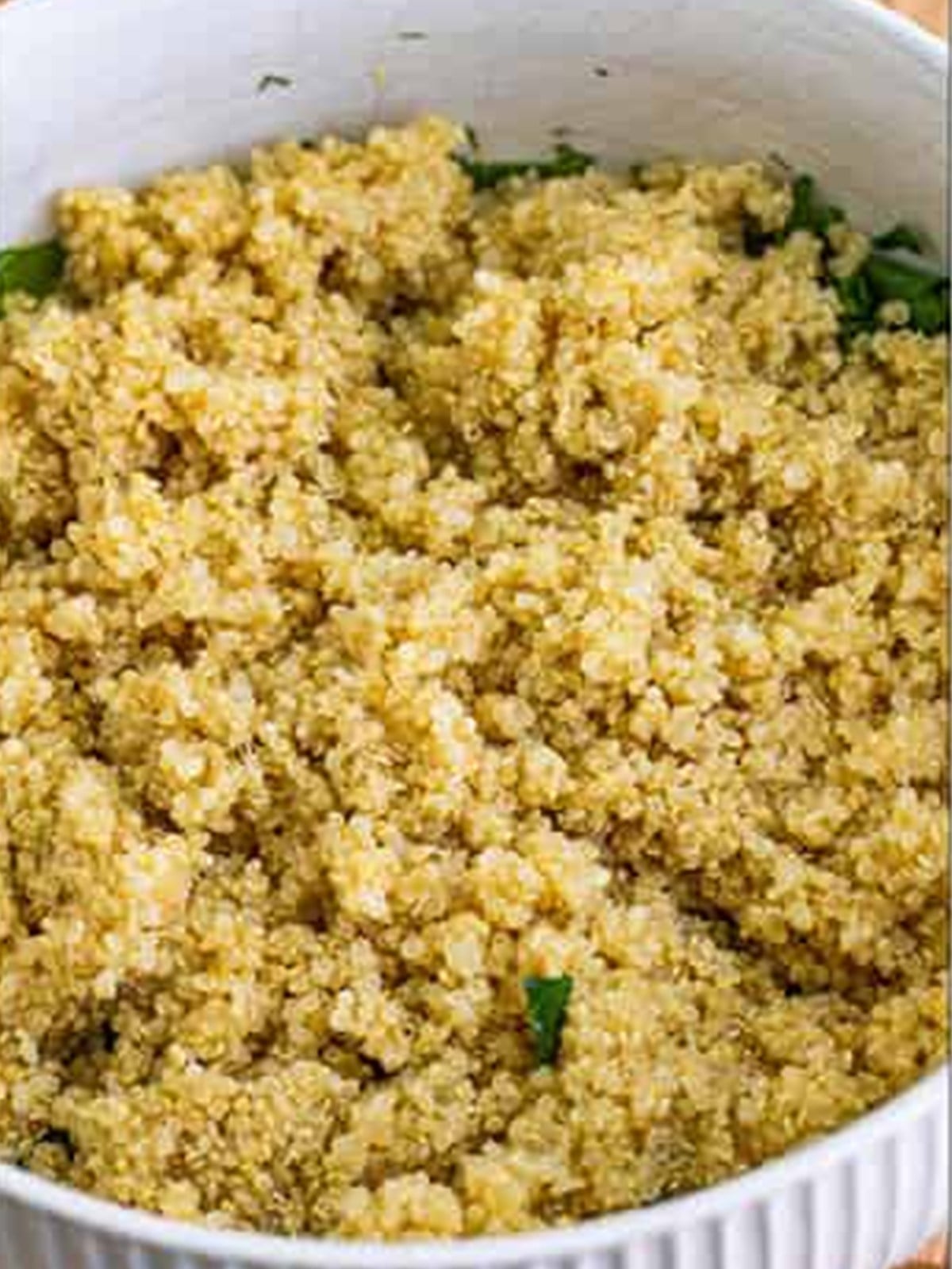 Cooked quinoa in a white bowl.