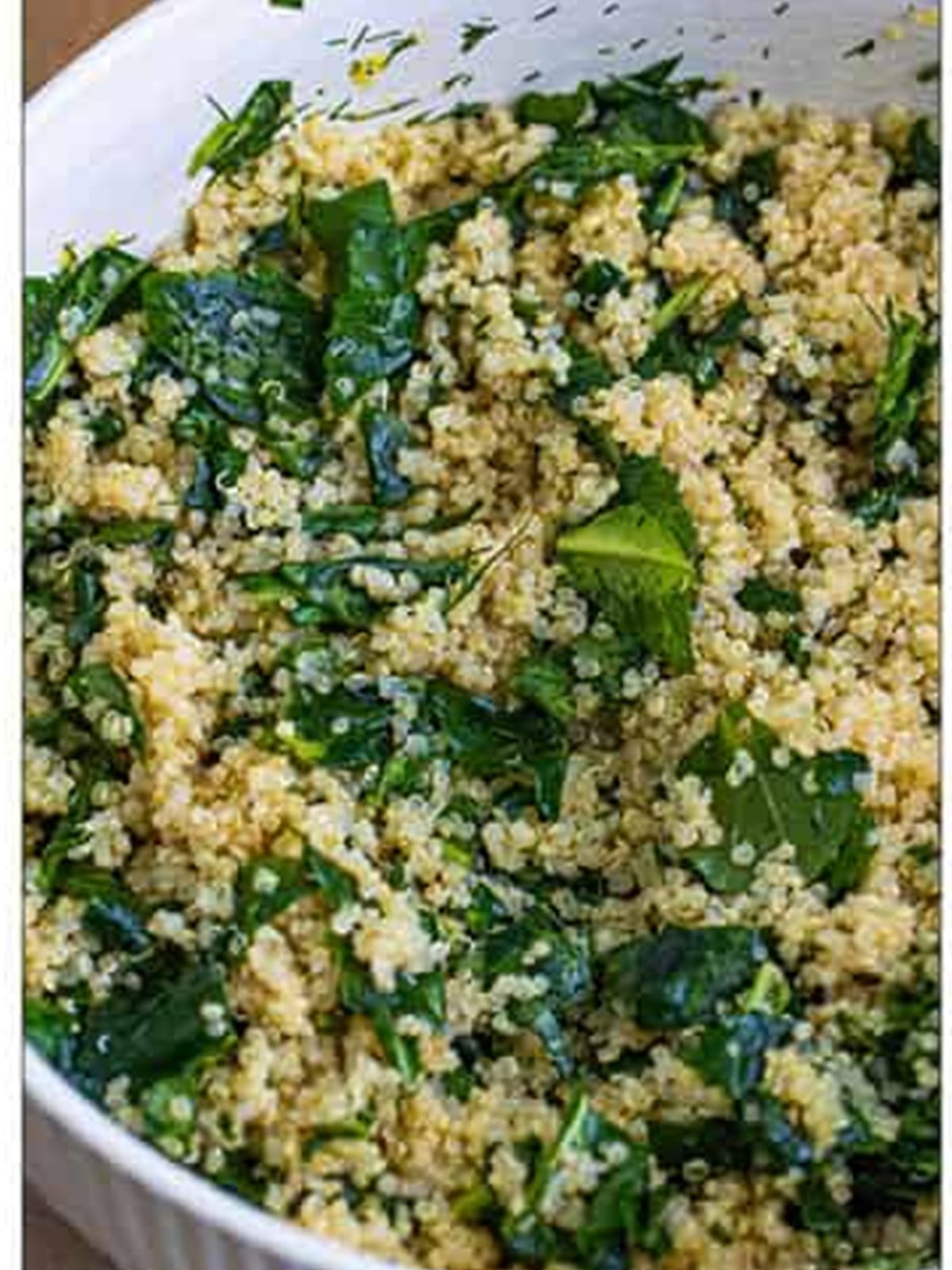 Kale and quinoa tossed together in a bowl.