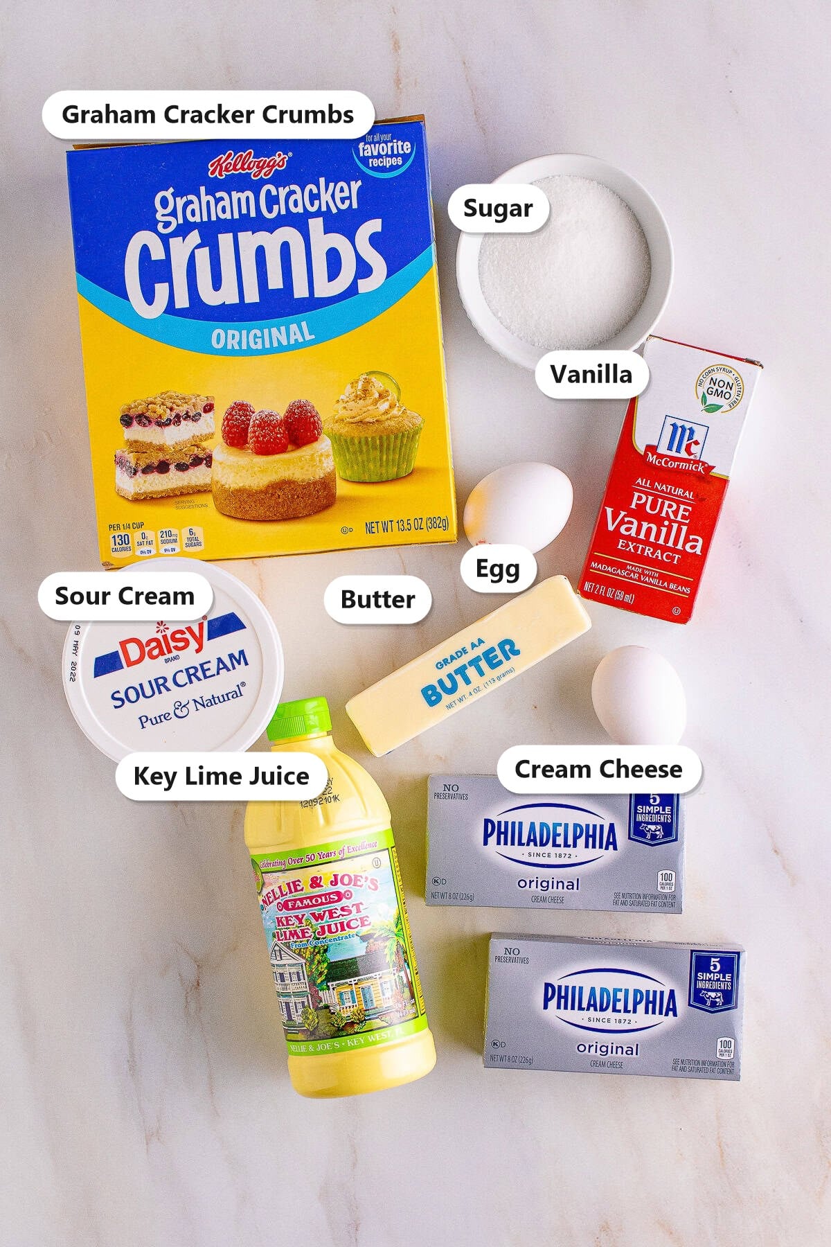 Graham cracker crumbs, sugar, vanilla, egg, butter, sour cream, key lime juice, and cream cheese labeled for Key Lime Cheesecake.