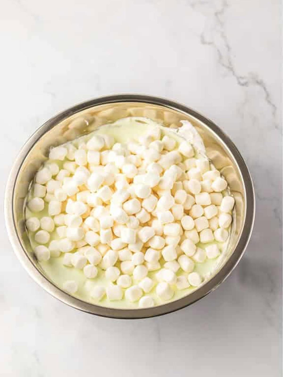 Mini marshmallows folded into the creamy key lime mixture for Key Lime Fluff Salad.
